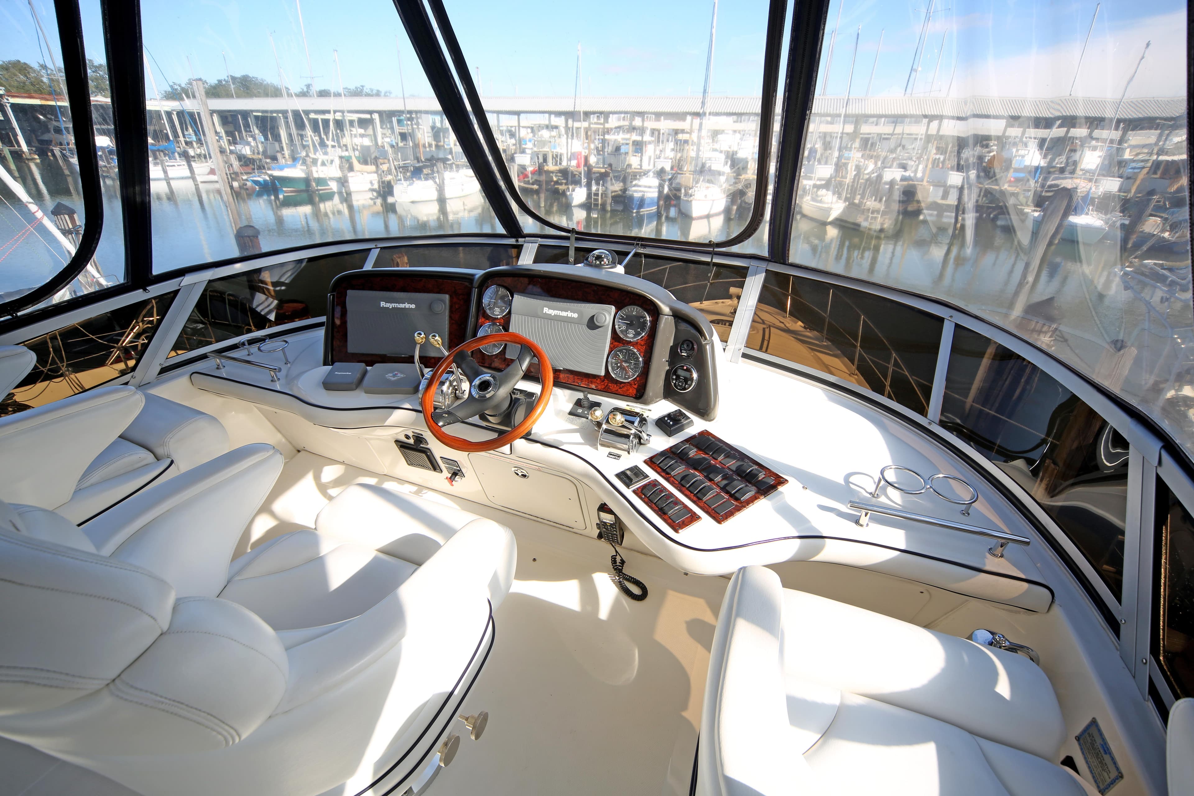 2007 Sea Ray 44 Sedan Bridge helm with modern controls and panoramic marina view.