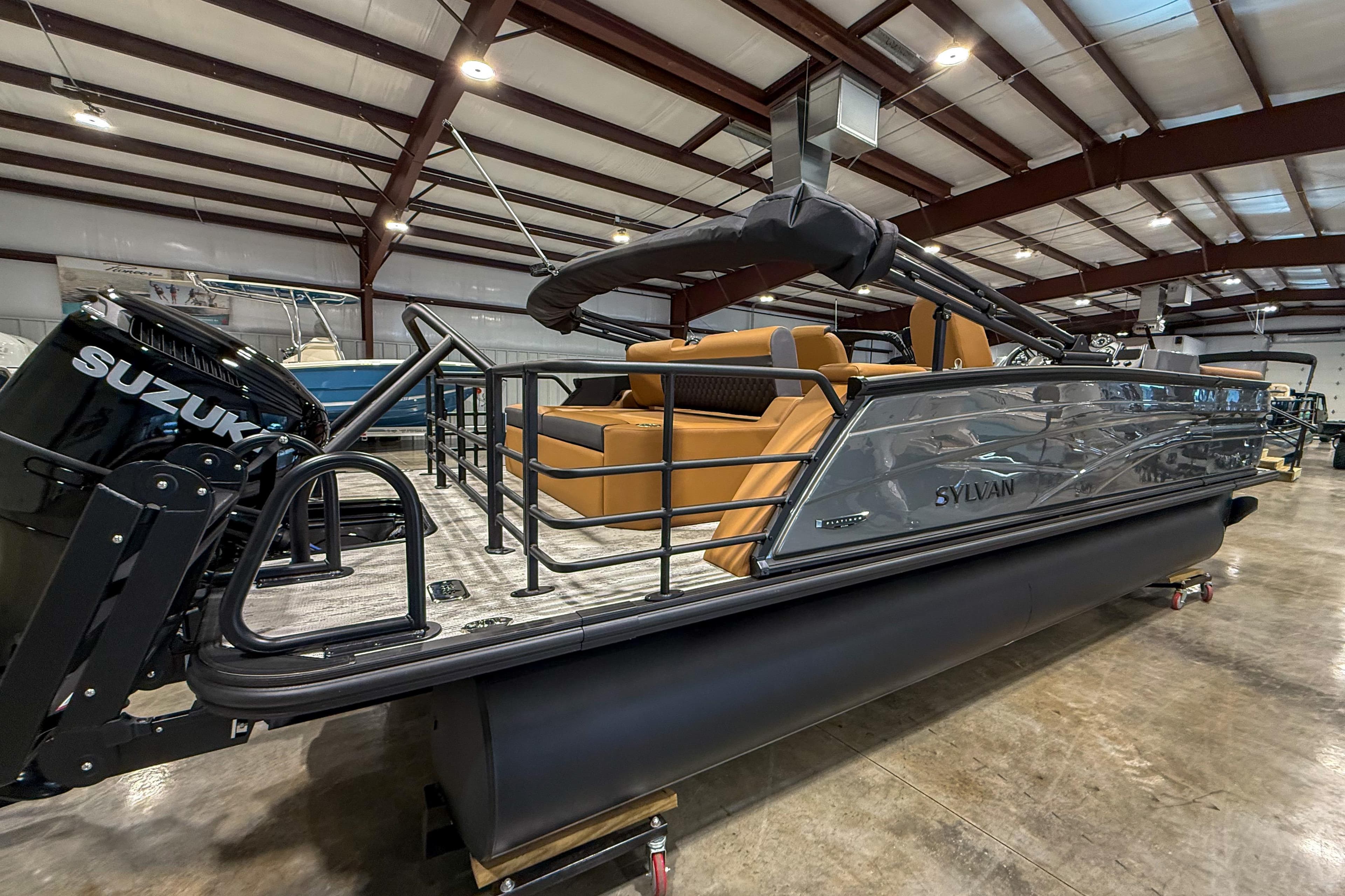 2026 Sylvan L3 LZ DH pontoon boat with Suzuki engine in showroom.
