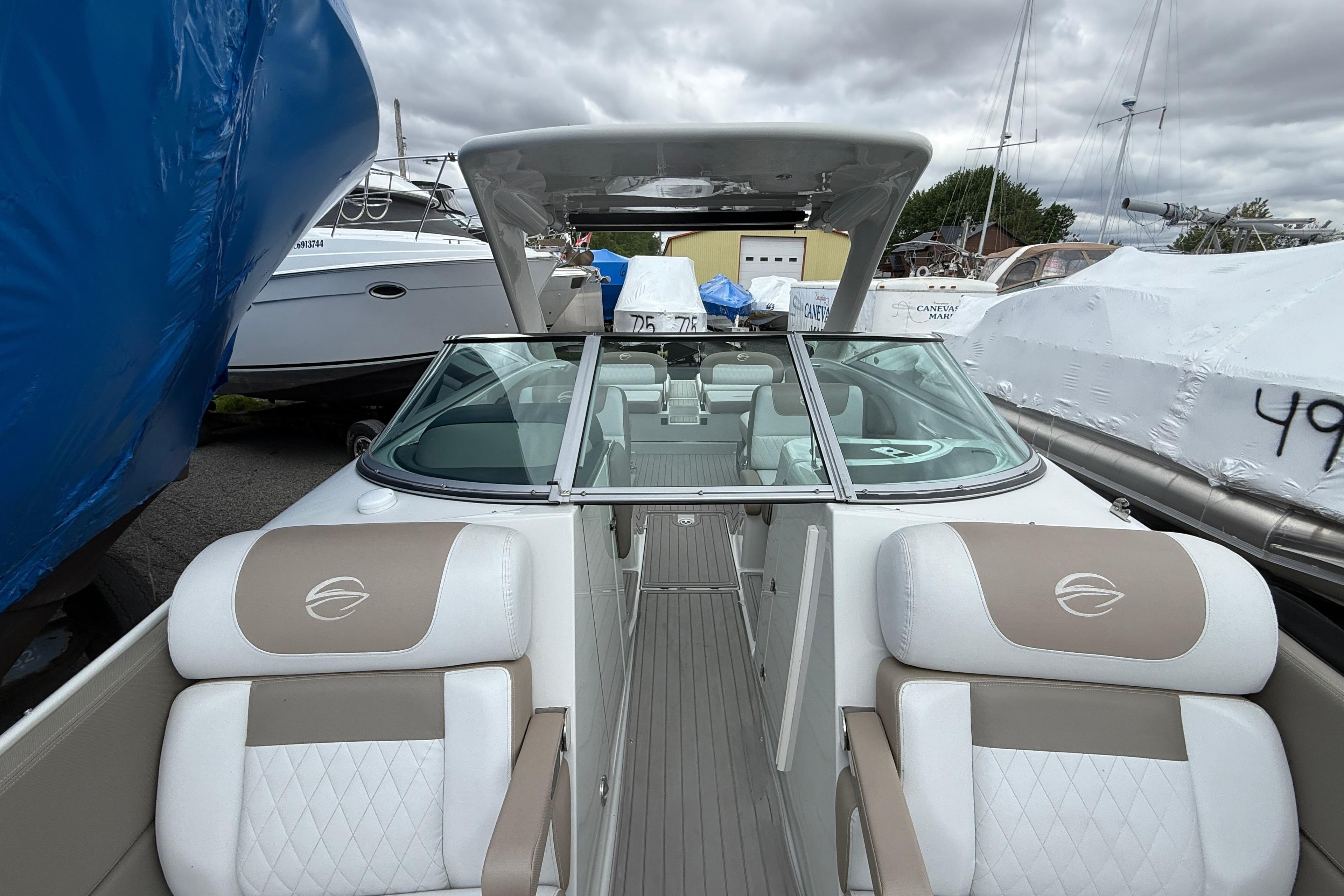2018 Crownline Eclipse E30 boat with sleek design and comfortable seating, docked outdoors.