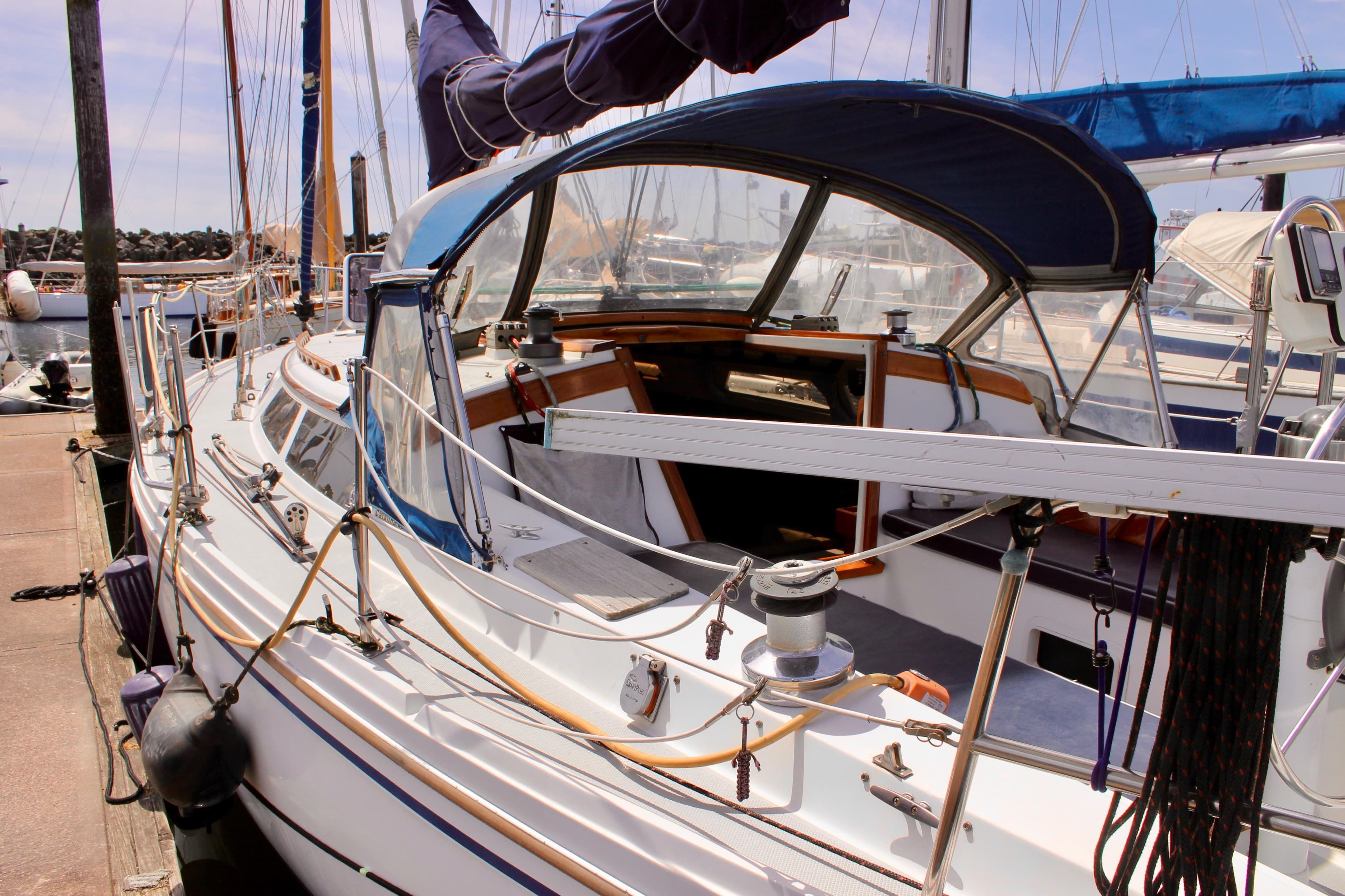 1989 Catalina 36 sailboat docked at marina, featuring spacious cockpit and rigging.