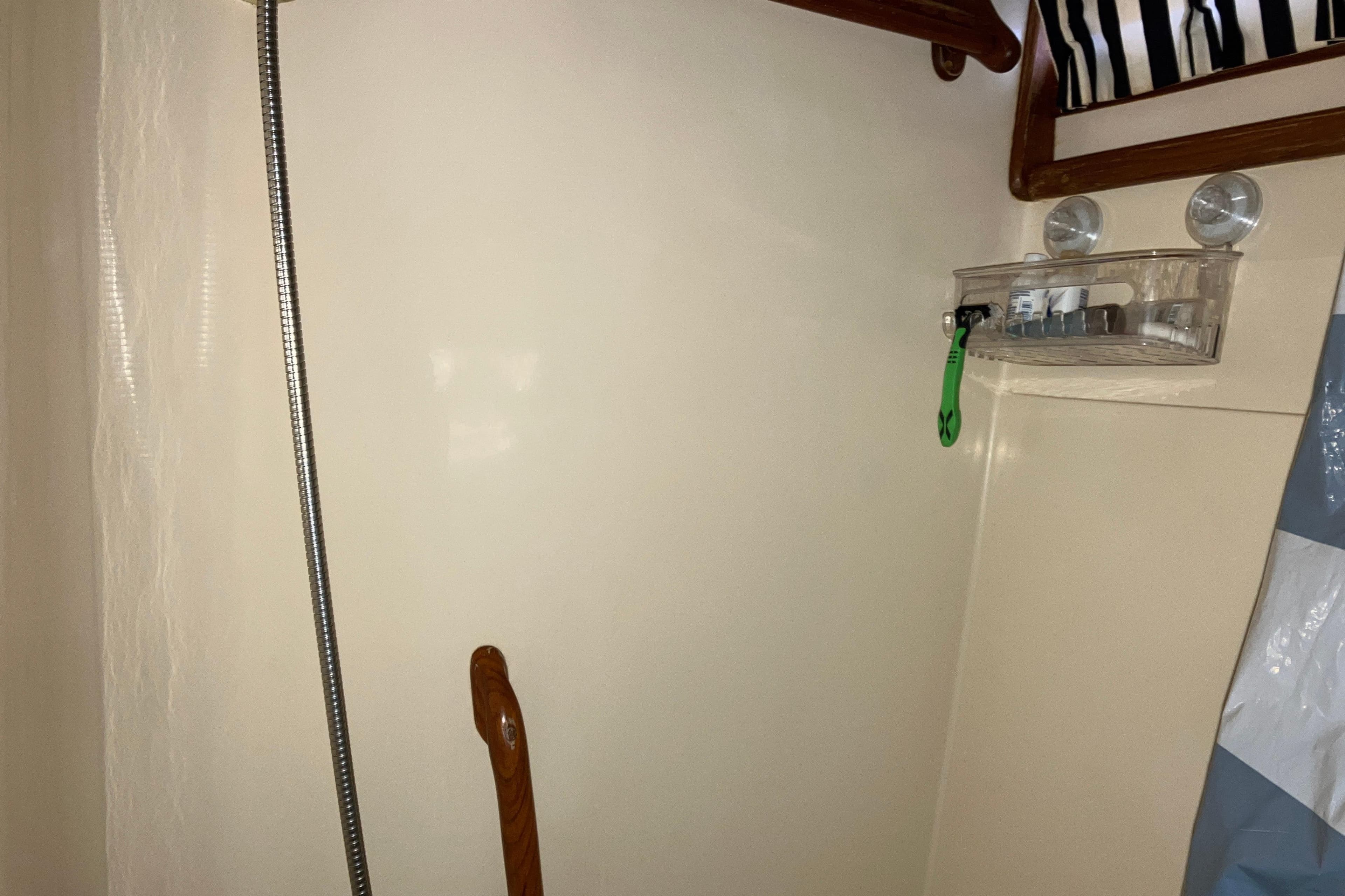 1987 President 37 Sundeck interior with shower area and storage shelf.