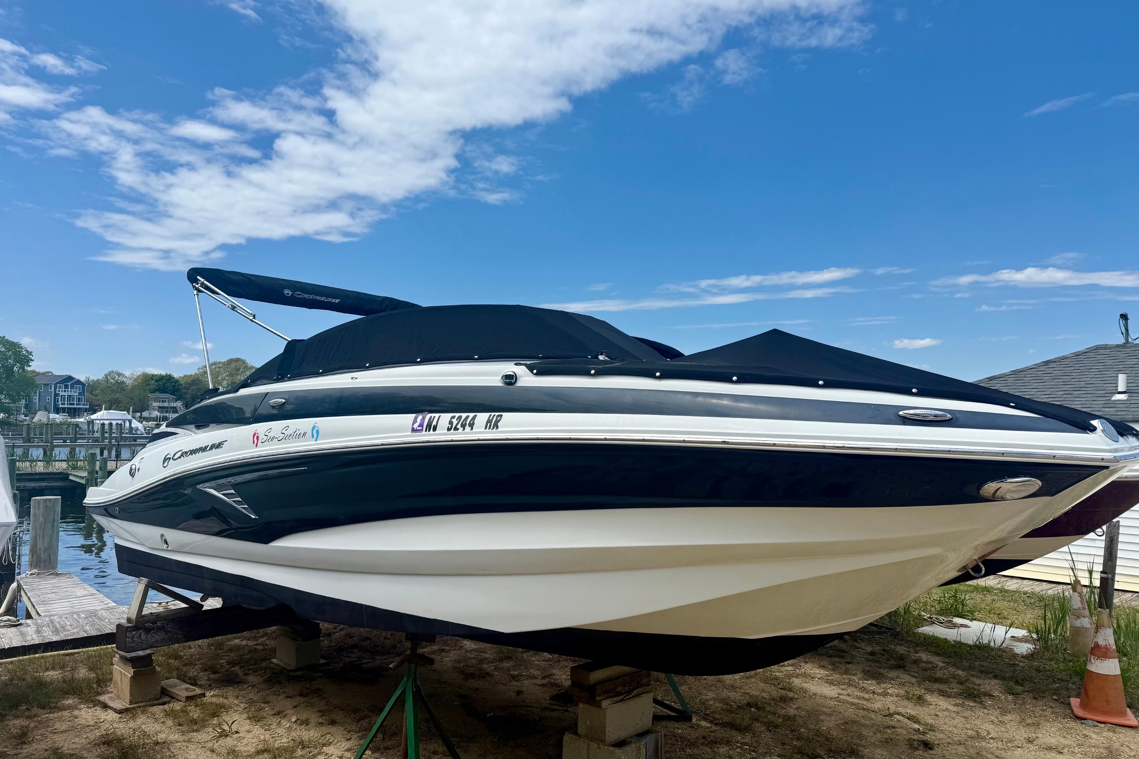 2020 Crownline Eclipse E235 boat docked under a clear blue sky.