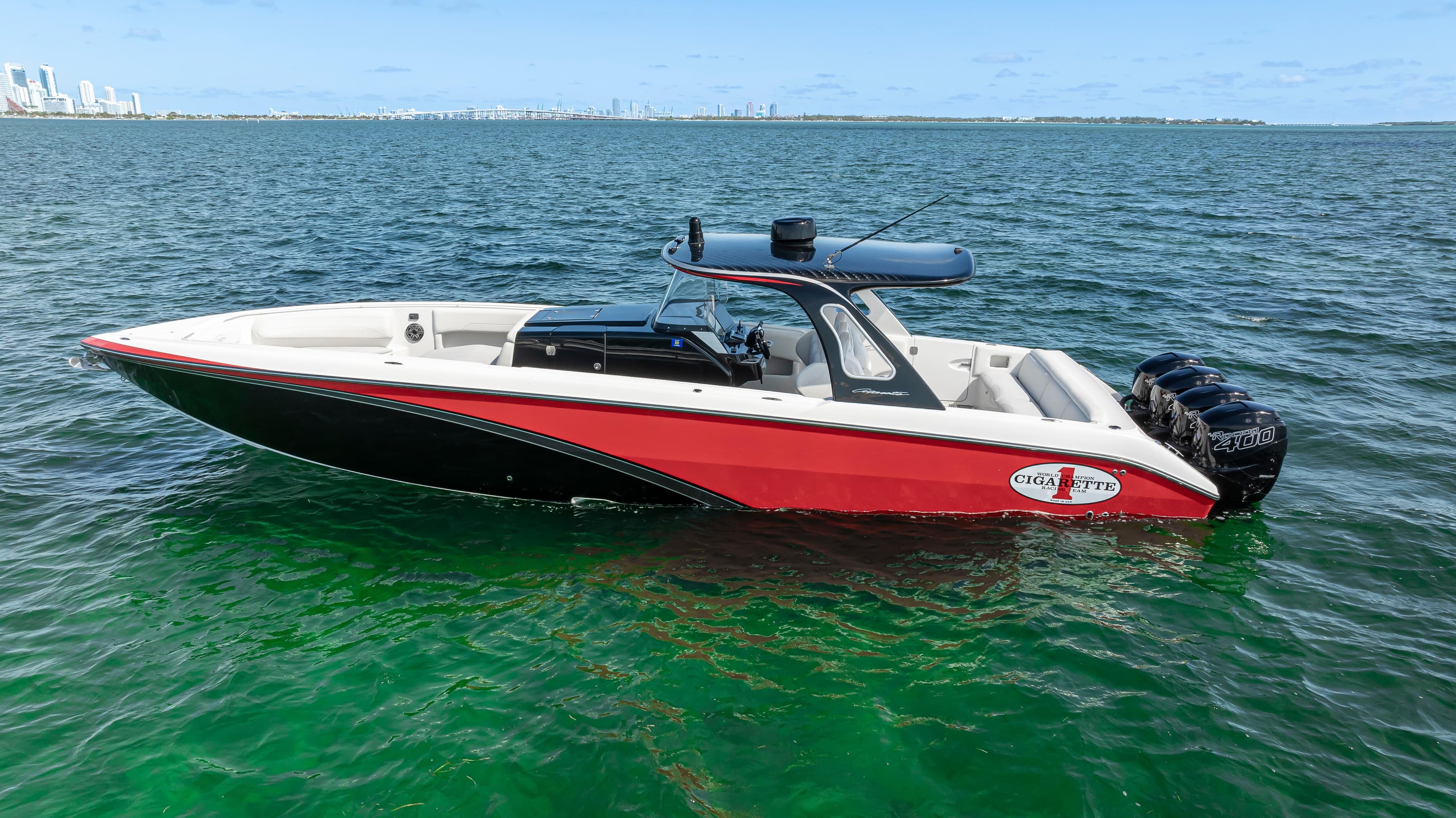 2016 Cigarette 41 GTR boat on open water, featuring sleek red and black design.