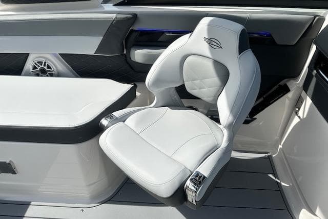Luxury seating on 2026 Chaparral 6 SSX boat, featuring sleek white and gray design.
