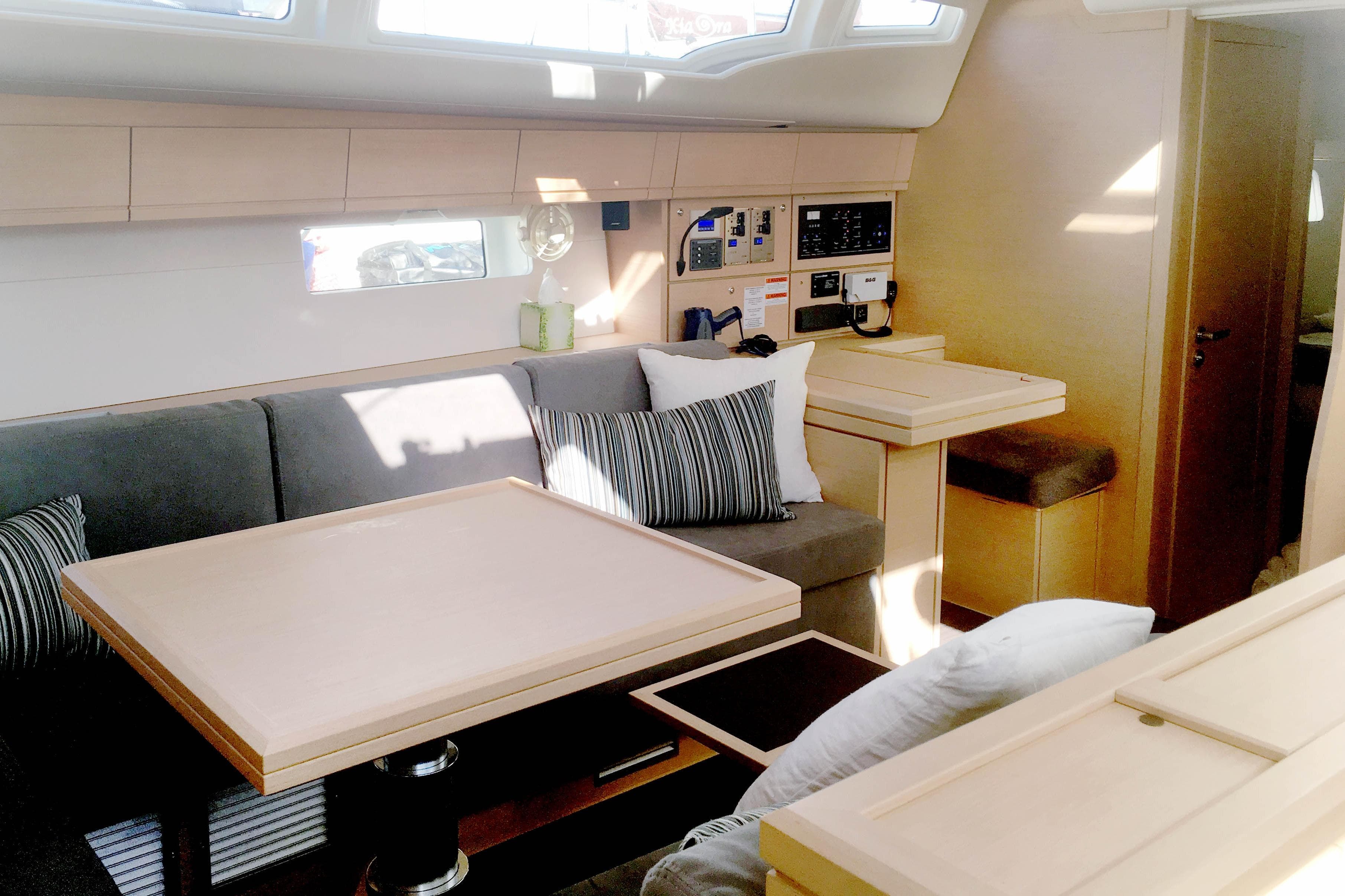 Luxurious interior of a 2017 Jeanneau 54 yacht with modern furnishings and control panel.