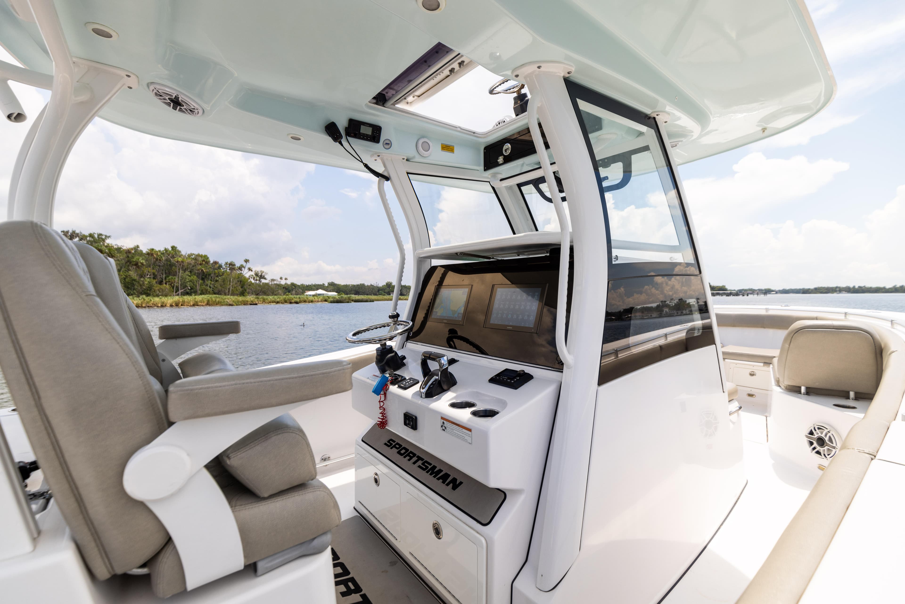 2021 Sportsman Open 302 Center Console boat interior with helm and seating.