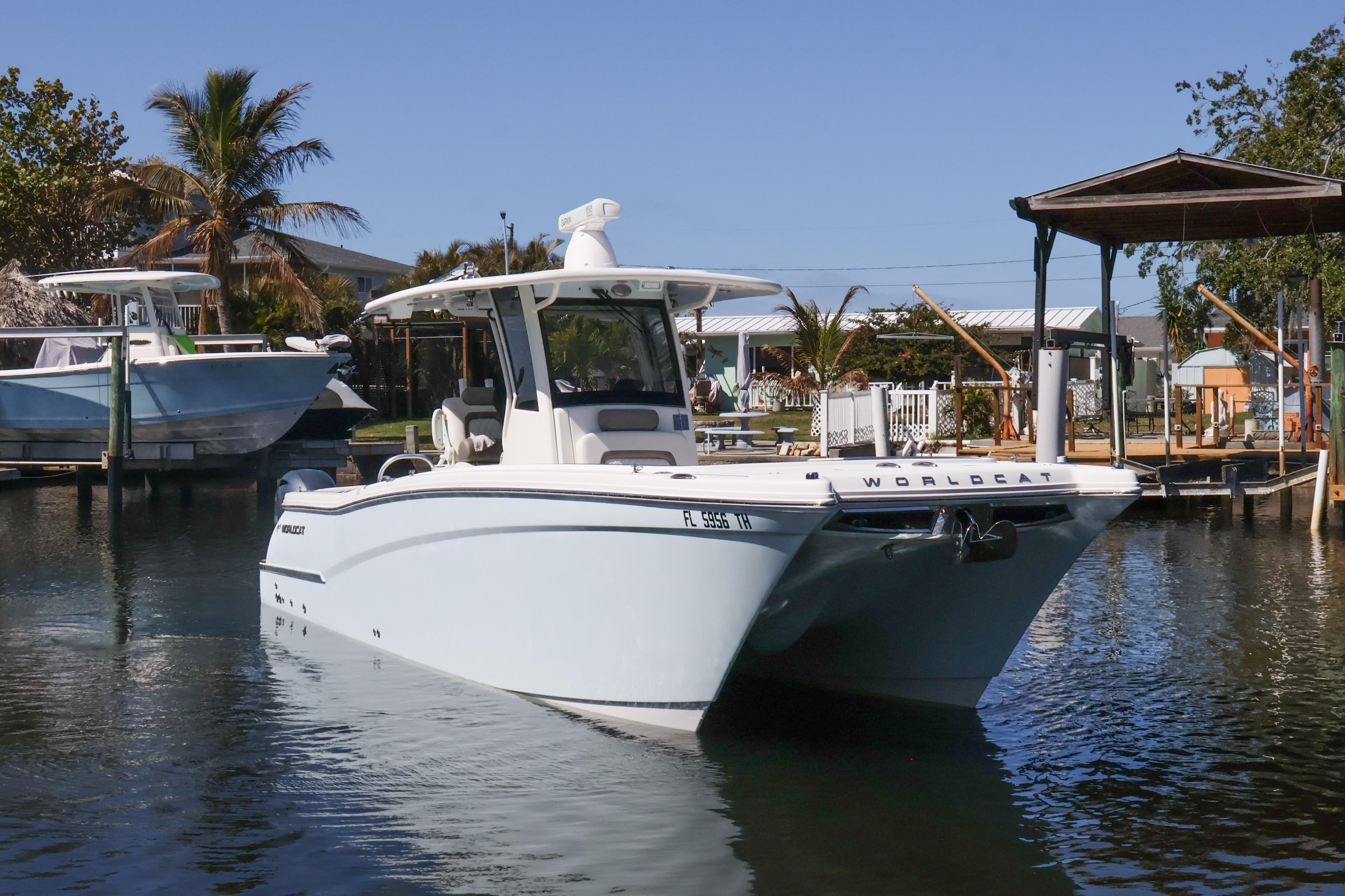 2022 World Cat 280 CC-X boat docked in a serene marina setting.