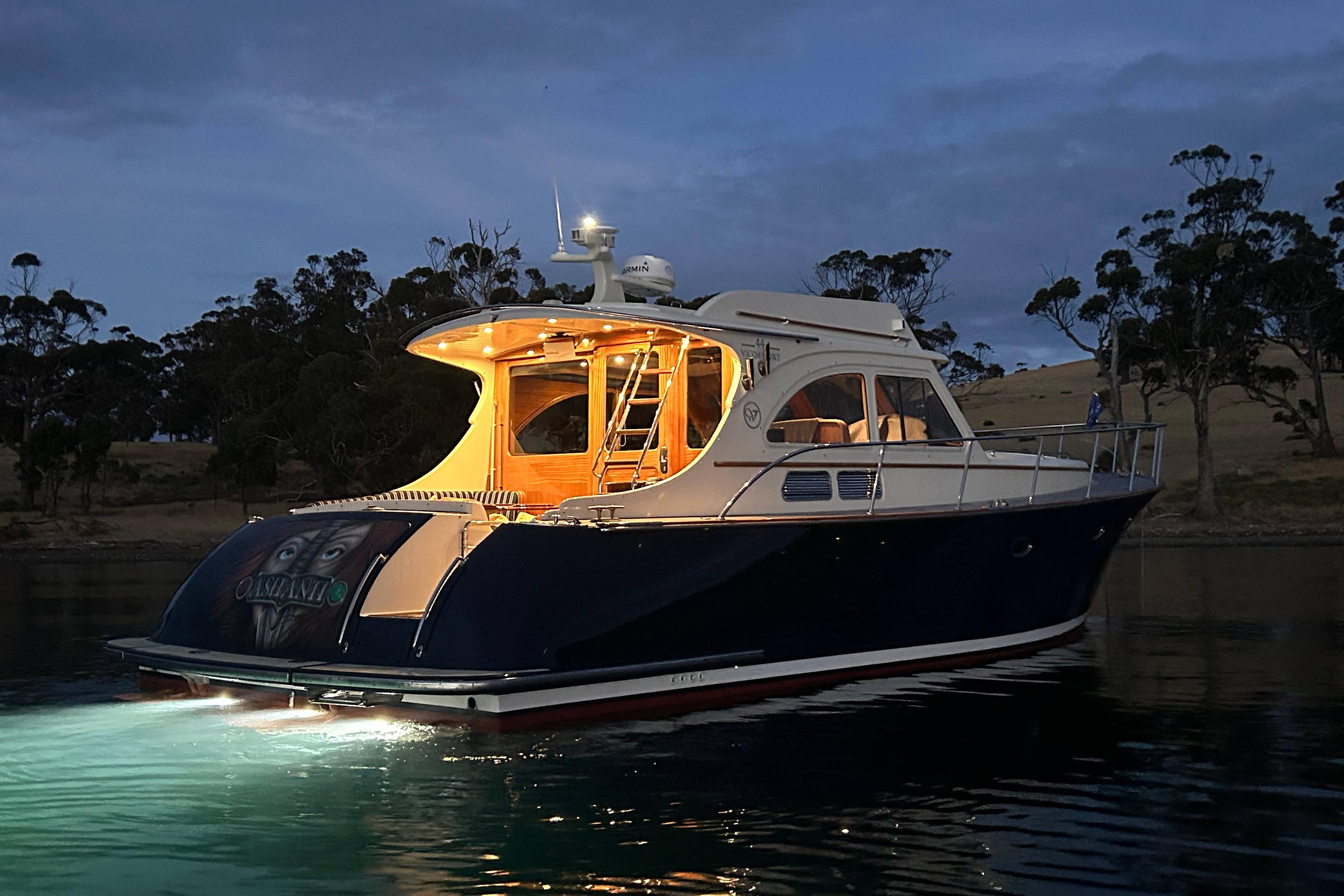2008 Vicem 44 yacht illuminated at dusk on calm waters.