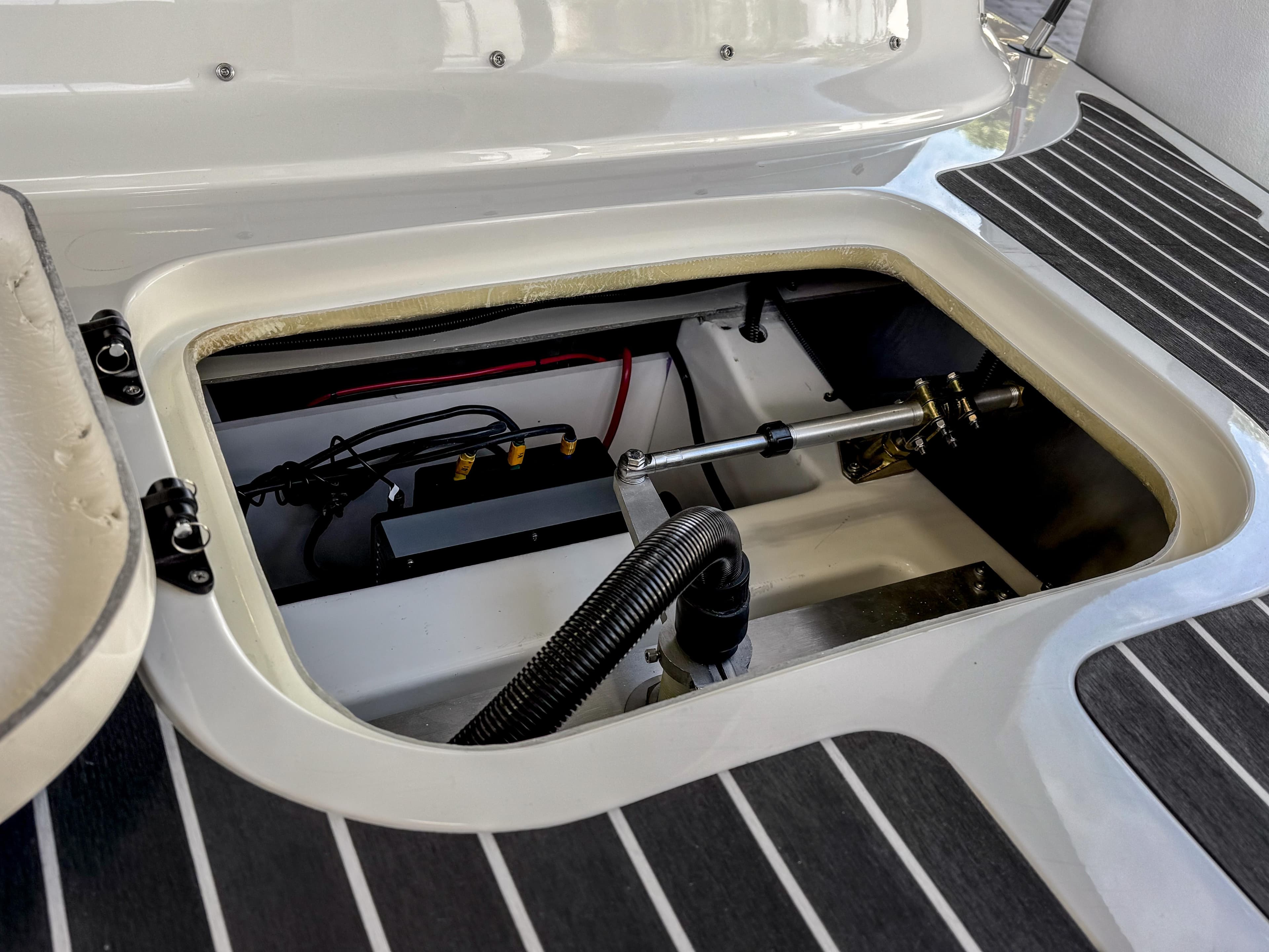 2024 Vision Marine Technologies Fantail 217 boat interior compartment with visible wiring and components.