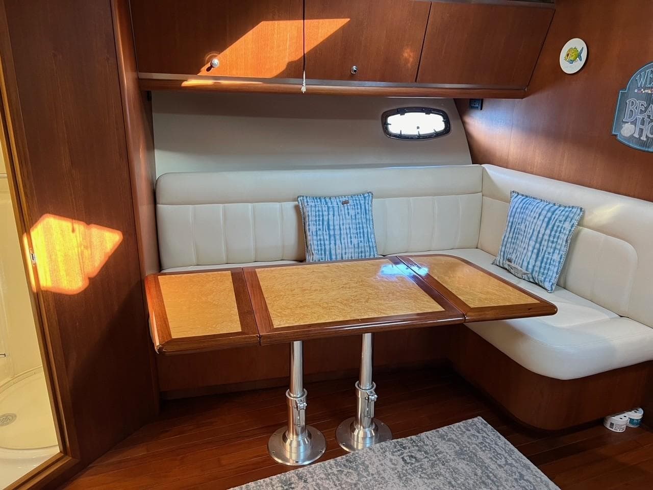 2005 Tiara Yachts 4200 Open interior with cozy seating and wooden table.