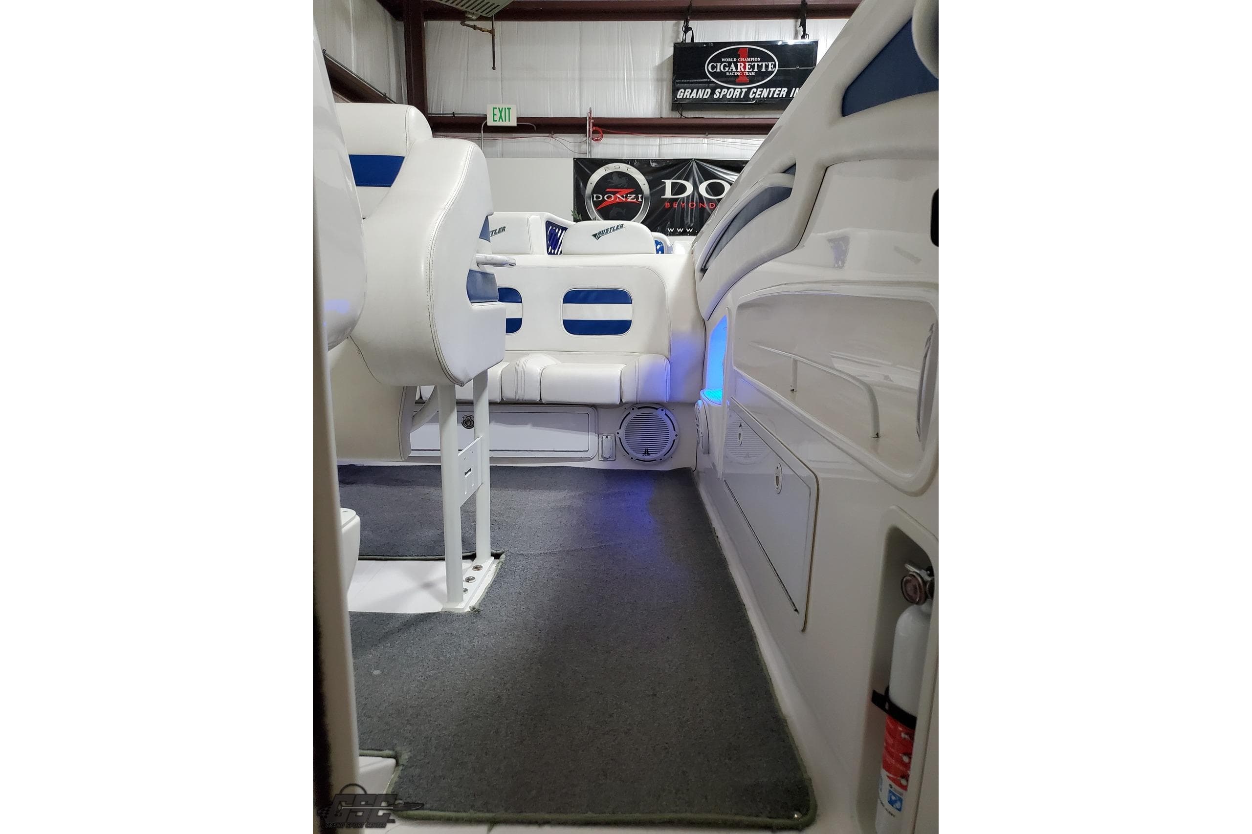 Interior of a 2001 Hustler 50 Monster boat with white seating and blue accents.