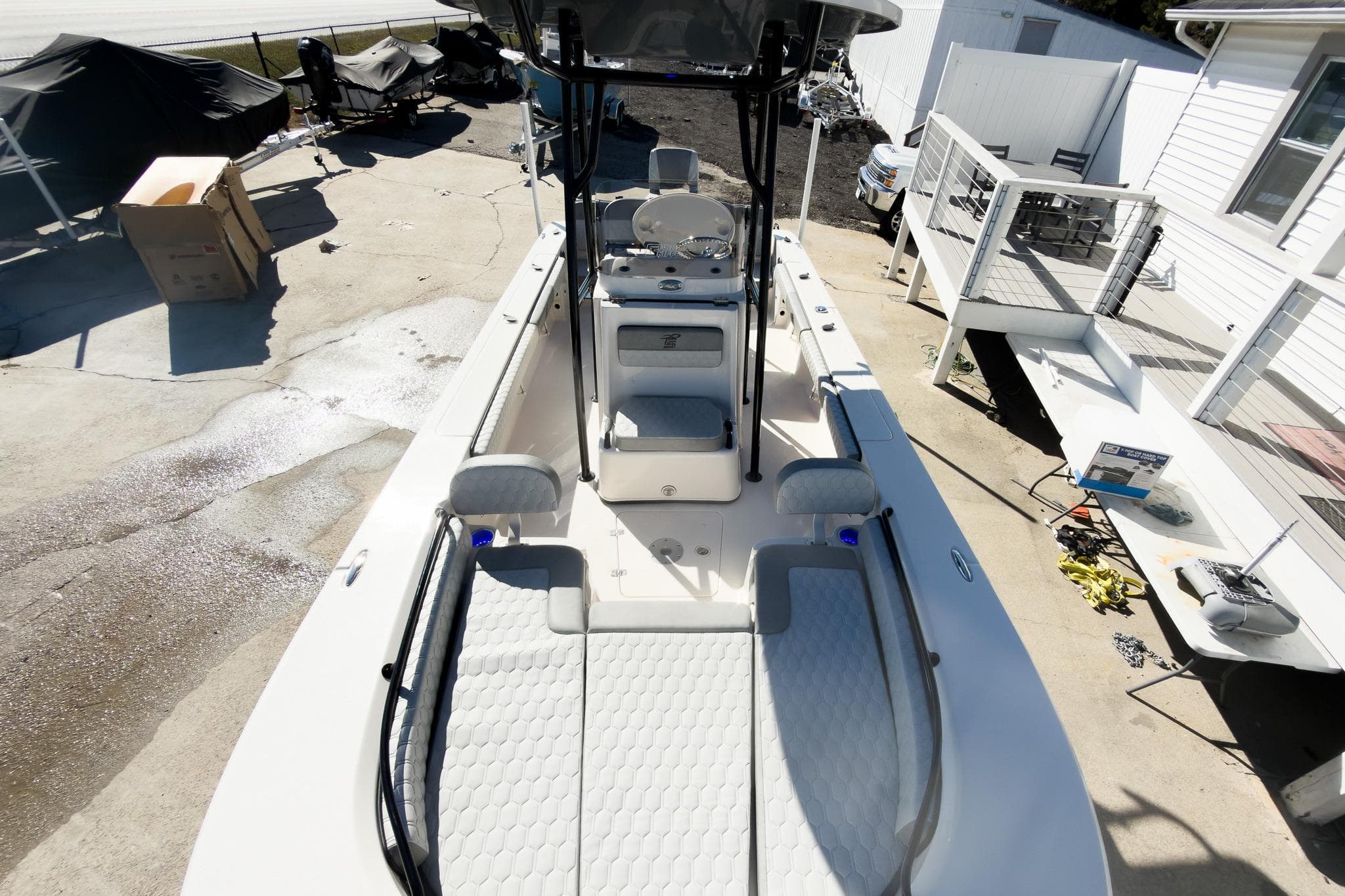 2026 Carolina Skiff 22 Ultra Elite boat, top view, docked near a house.