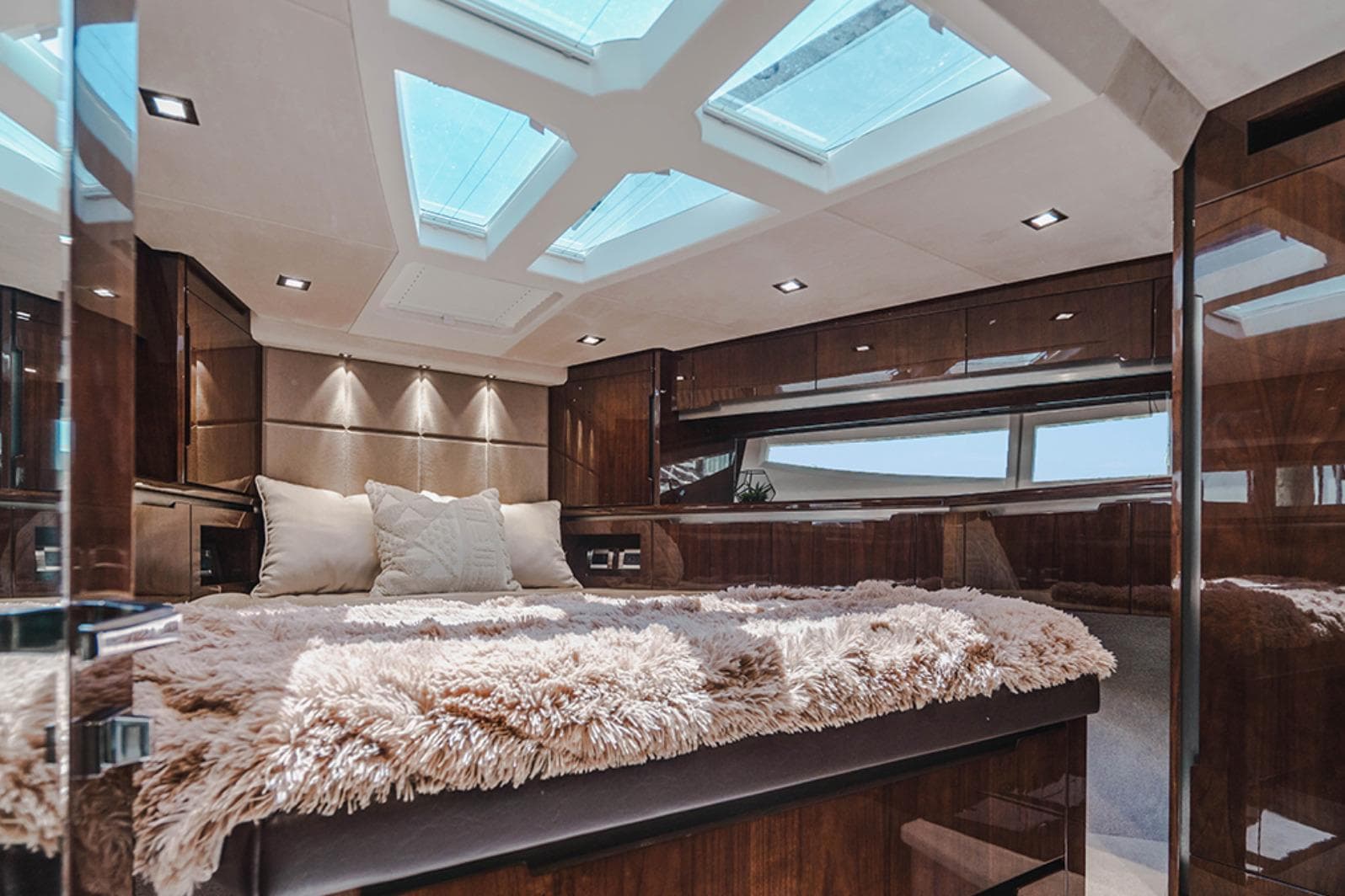 Luxurious interior of 2024 Galeon 470 Sky yacht with plush bedding and skylights.