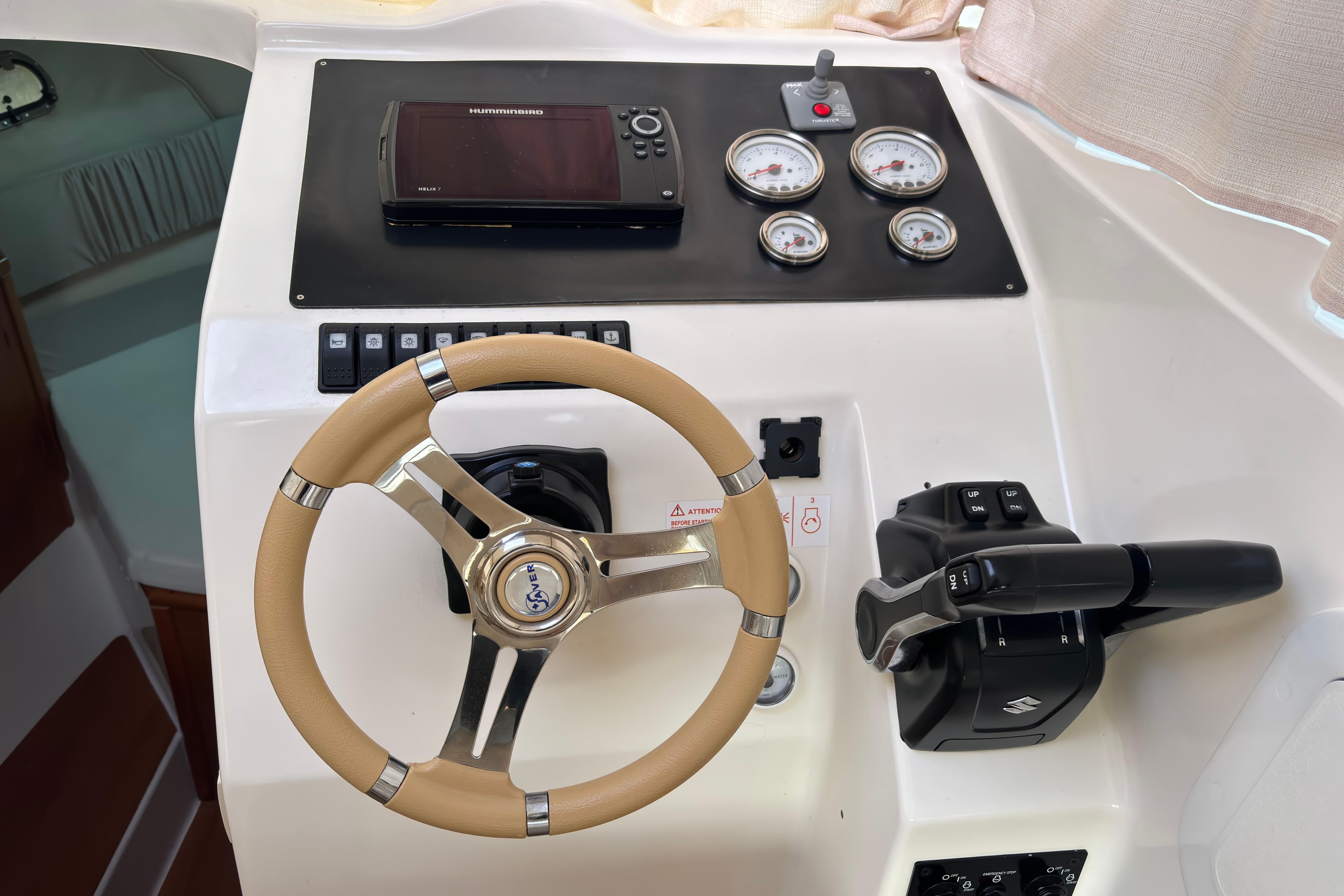 Steering console of a 2016 Saver 300 boat with gauges and controls.