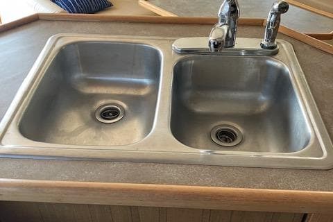 Stainless steel double sink in 2001 Bayliner 3988 Motoryacht kitchen area.