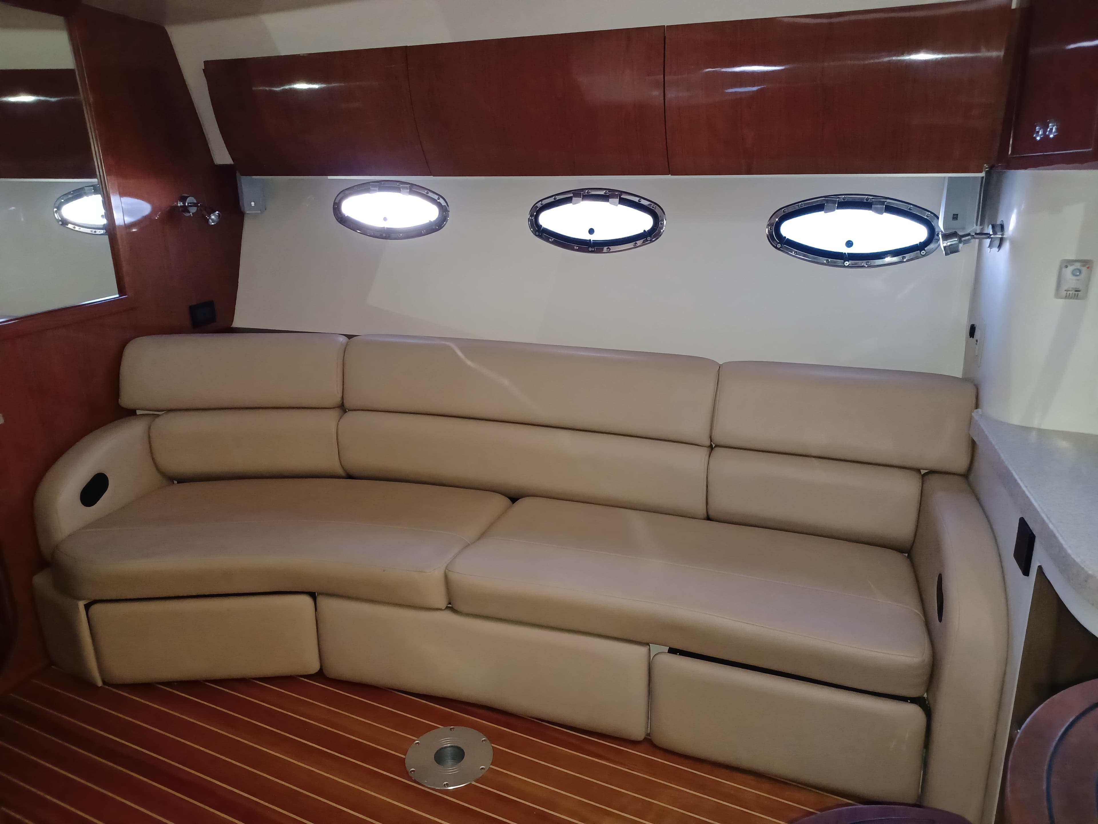 Luxurious interior of 2008 Regal 4060 COMMODORE yacht with beige leather seating.