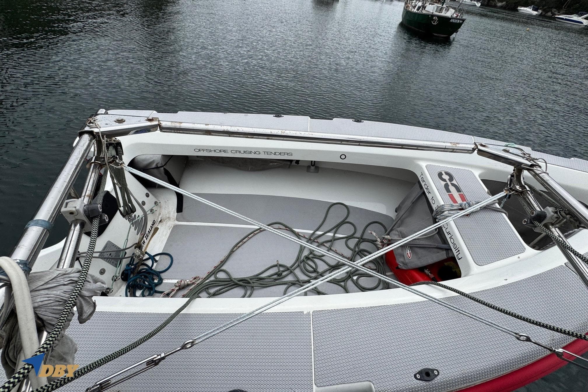 1998 Island Packet 45 sailboat deck with ropes and equipment, moored on calm water.