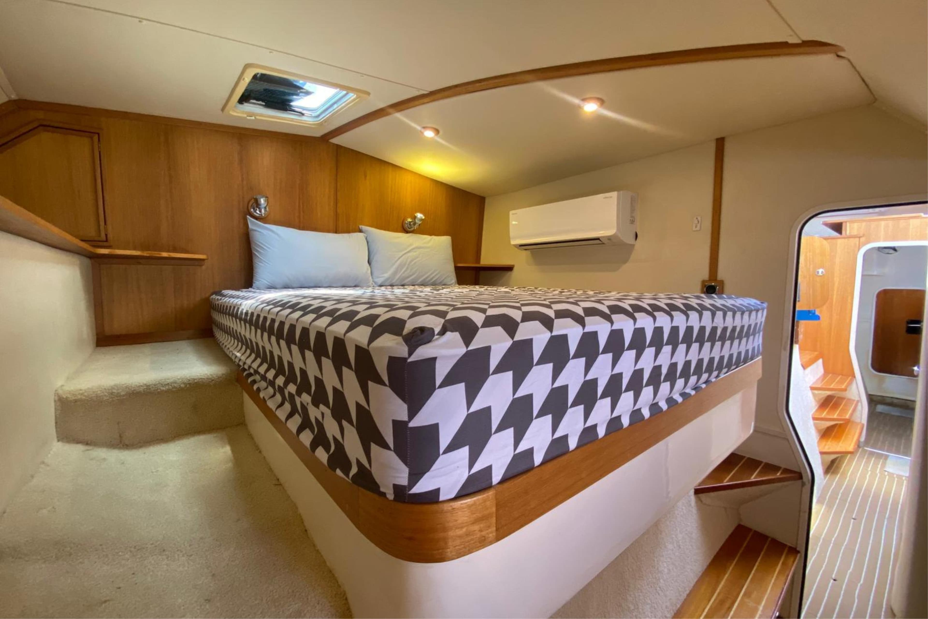 Luxurious cabin interior of 2007 Sun Yachts Custom 56 Power Cat with modern bedding.