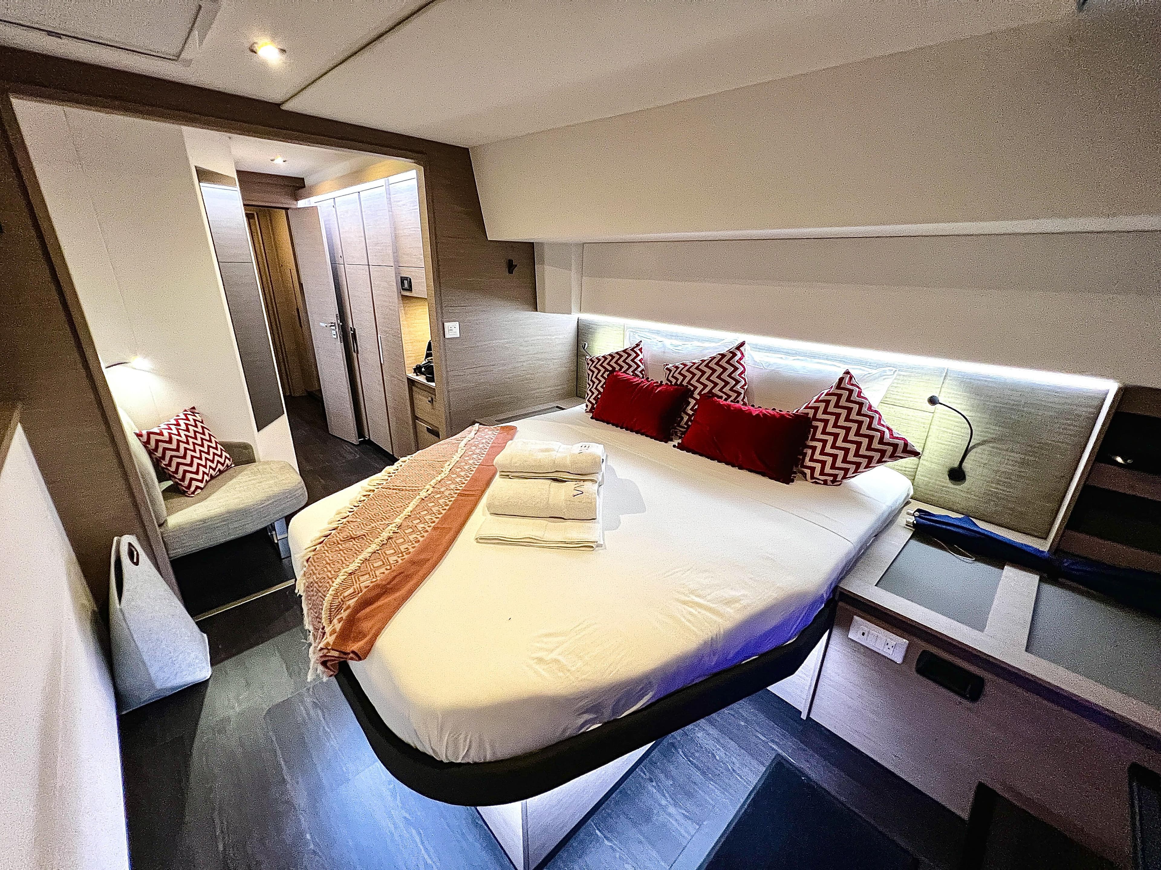 Luxurious bedroom interior of 2022 Fountaine Pajot Catamaran Aura 51 with modern decor.