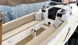 2026 J Boats J9 sailboat with beige seating and striped cushions on deck.