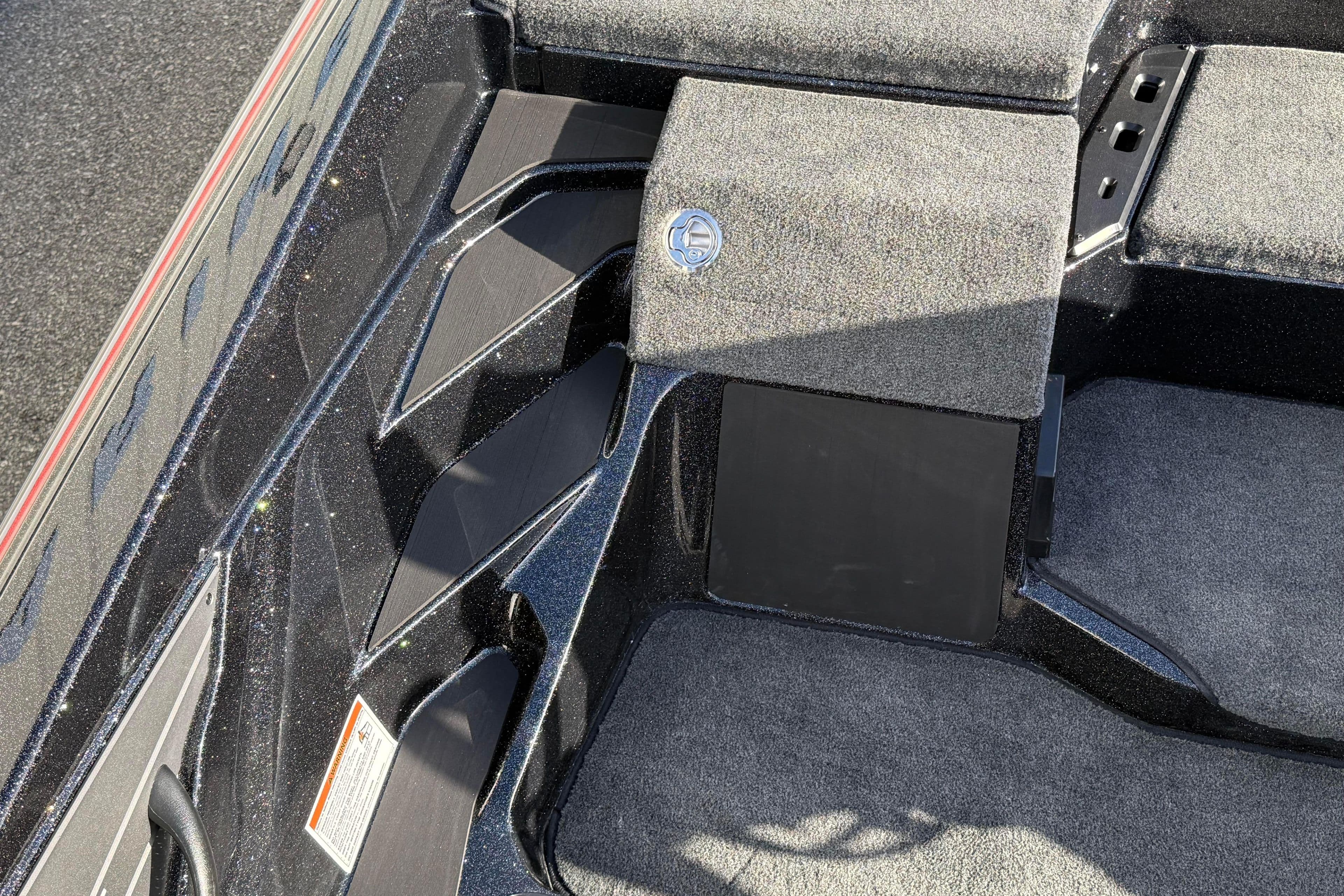 Interior view of 2026 Skeeter ZXE20 boat with carpeted flooring and storage compartments.