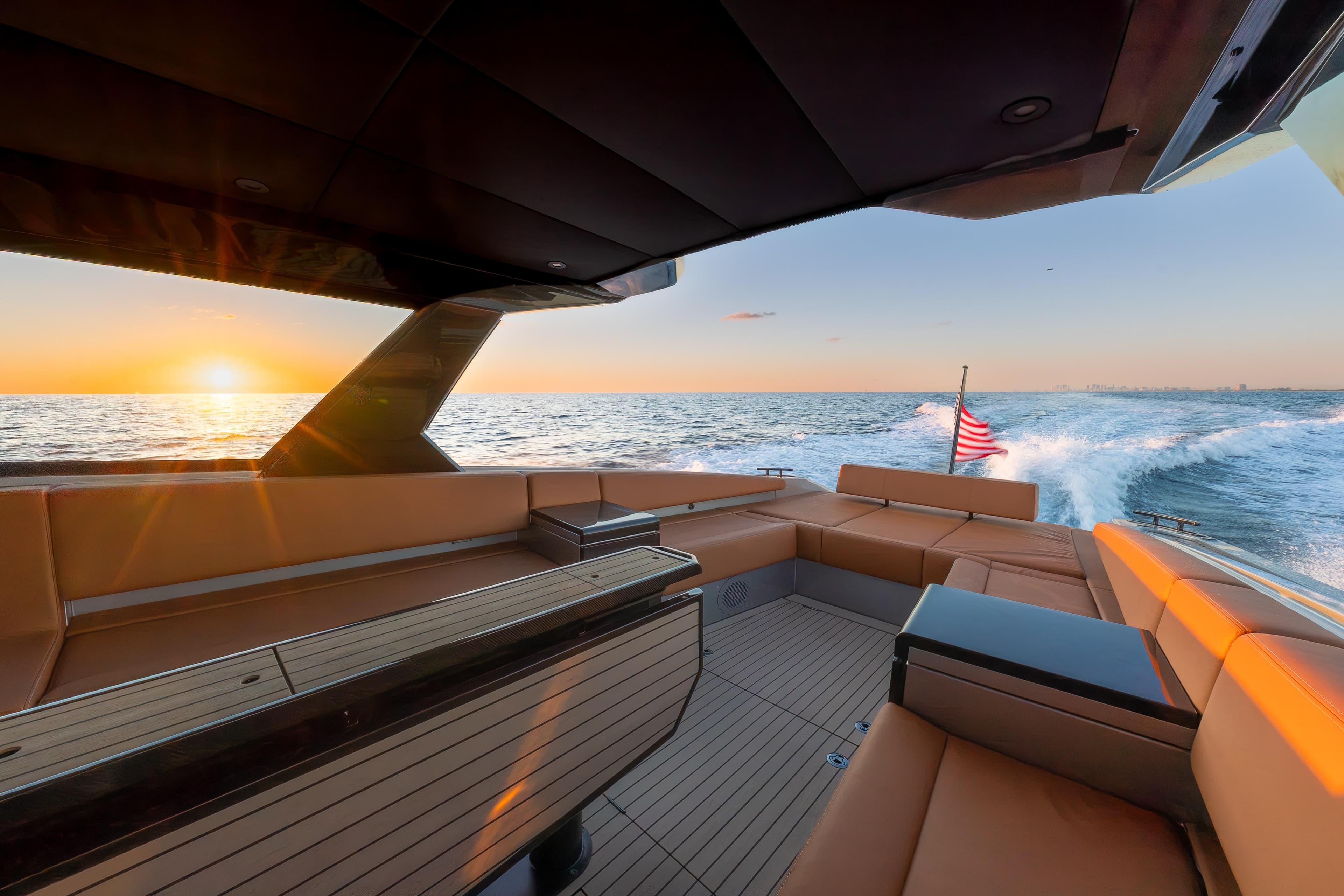 2024 Wajer 55 HT yacht interior with sunset ocean view and American flag.