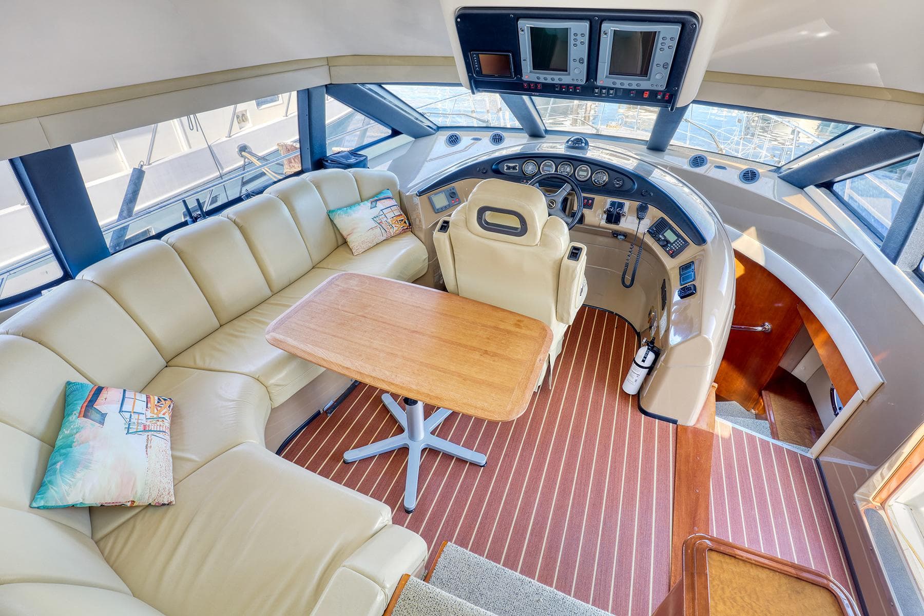 Luxurious 2005 Carver 560 Voyager yacht interior with leather seating and modern helm.