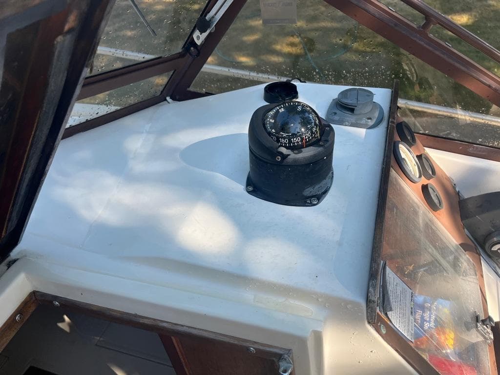 1989 Mako 210 WA boat dashboard with compass and gauges.