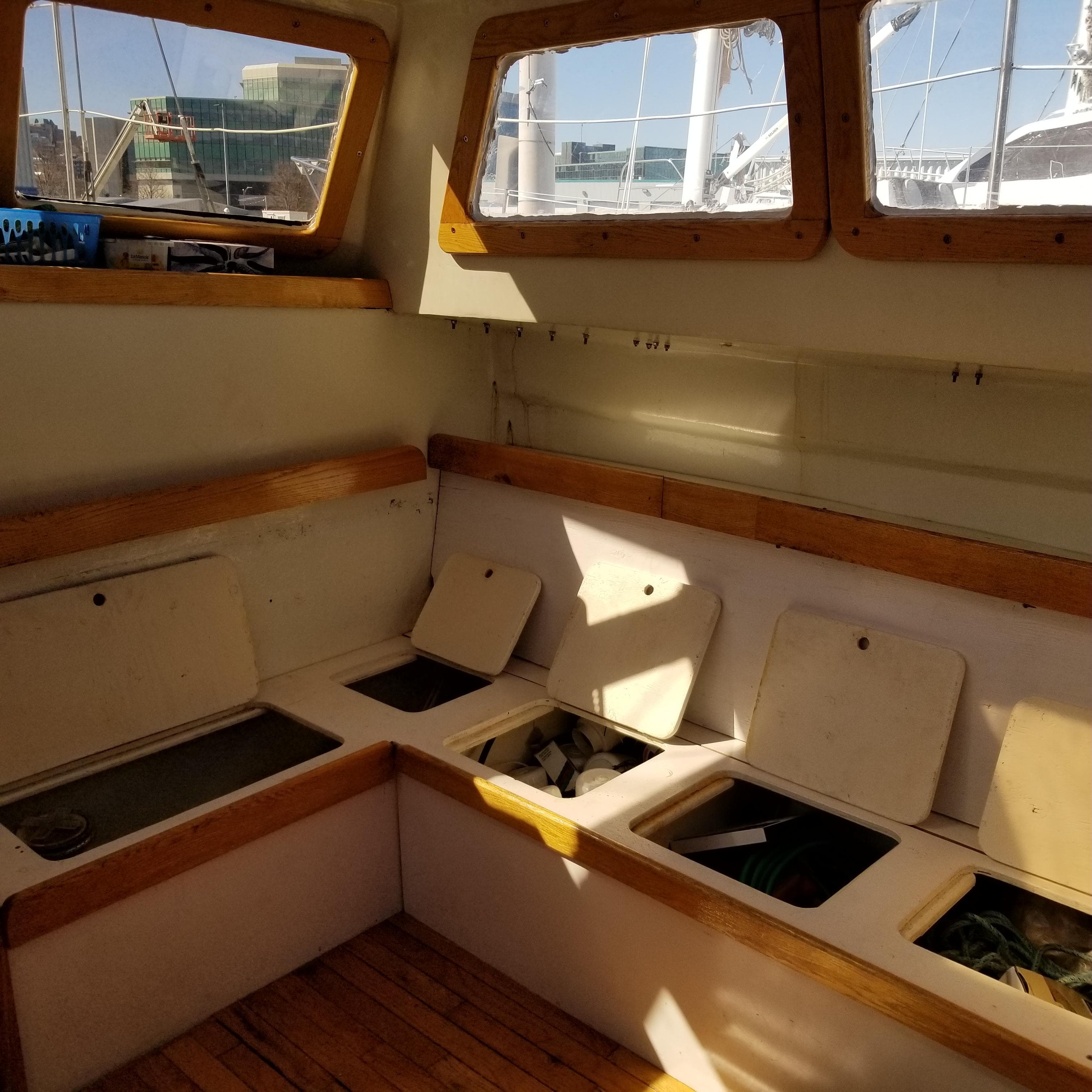 Interior of 2001 Endurance 35 sailboat with open storage compartments and wooden trim.