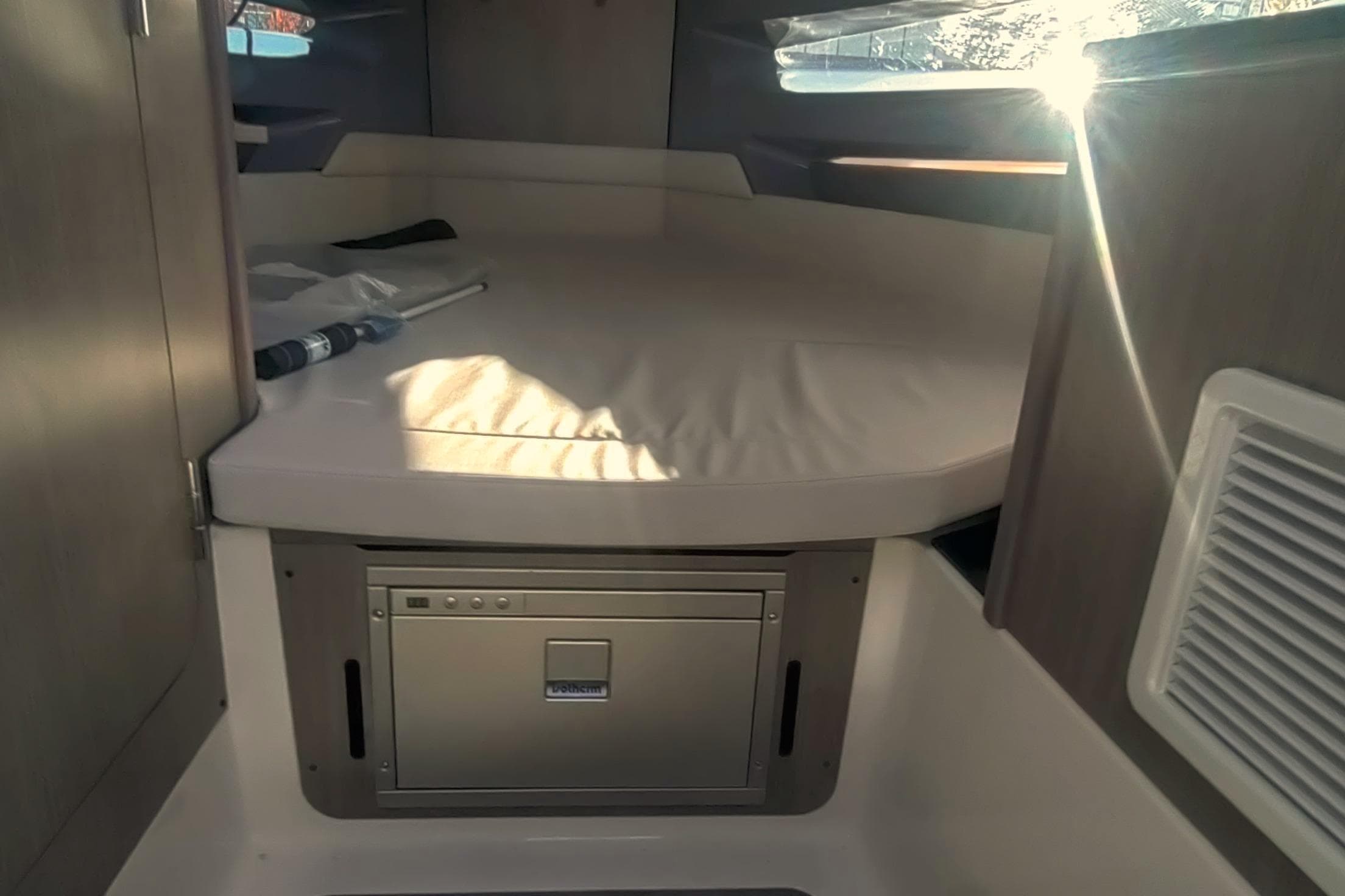 2026 Navan C30 cabin interior with bed and storage compartment.
