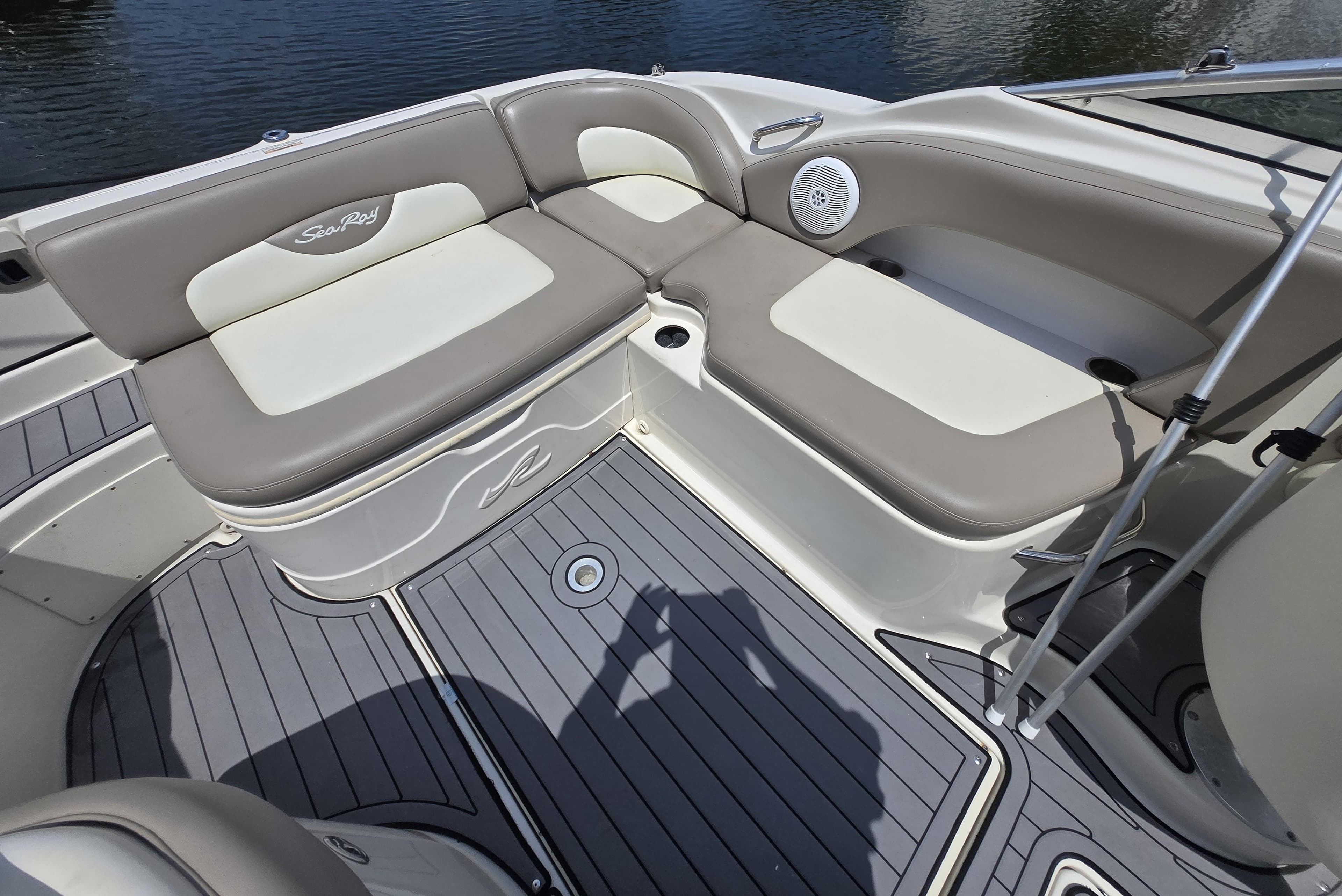 2006 Sea Ray 270 Sundeck interior with cushioned seating and speaker, on water.