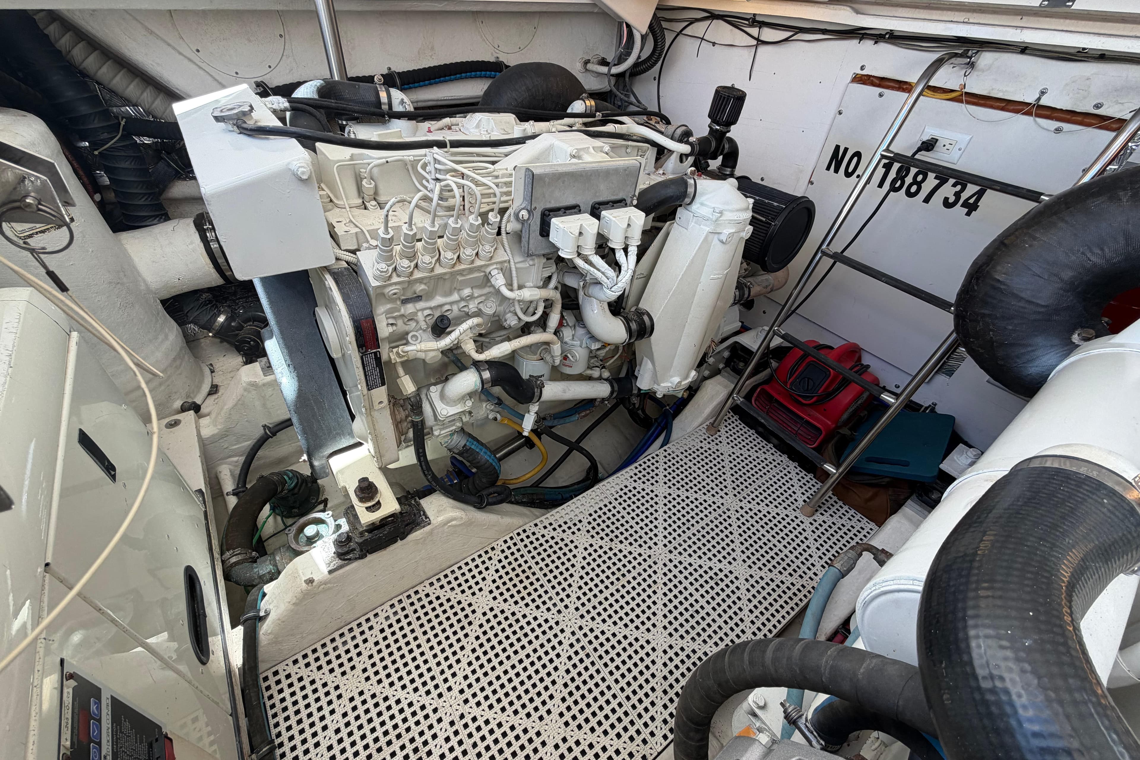 Engine room of a 2005 Tiara Yachts 3600 Sovran, showcasing mechanical components and equipment.