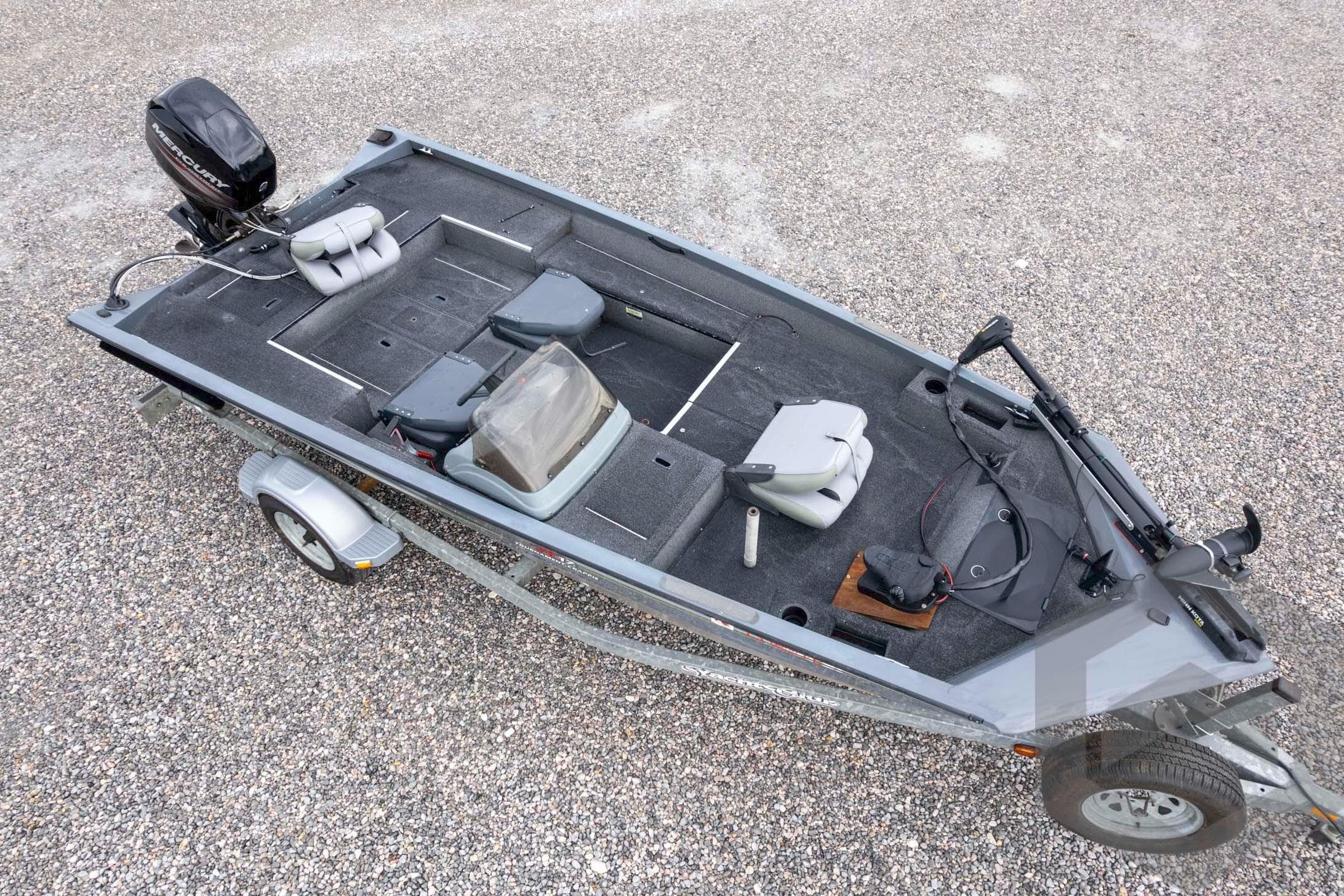 2007 Triton TC-17 fishing boat on trailer, featuring spacious deck and Mercury outboard motor.