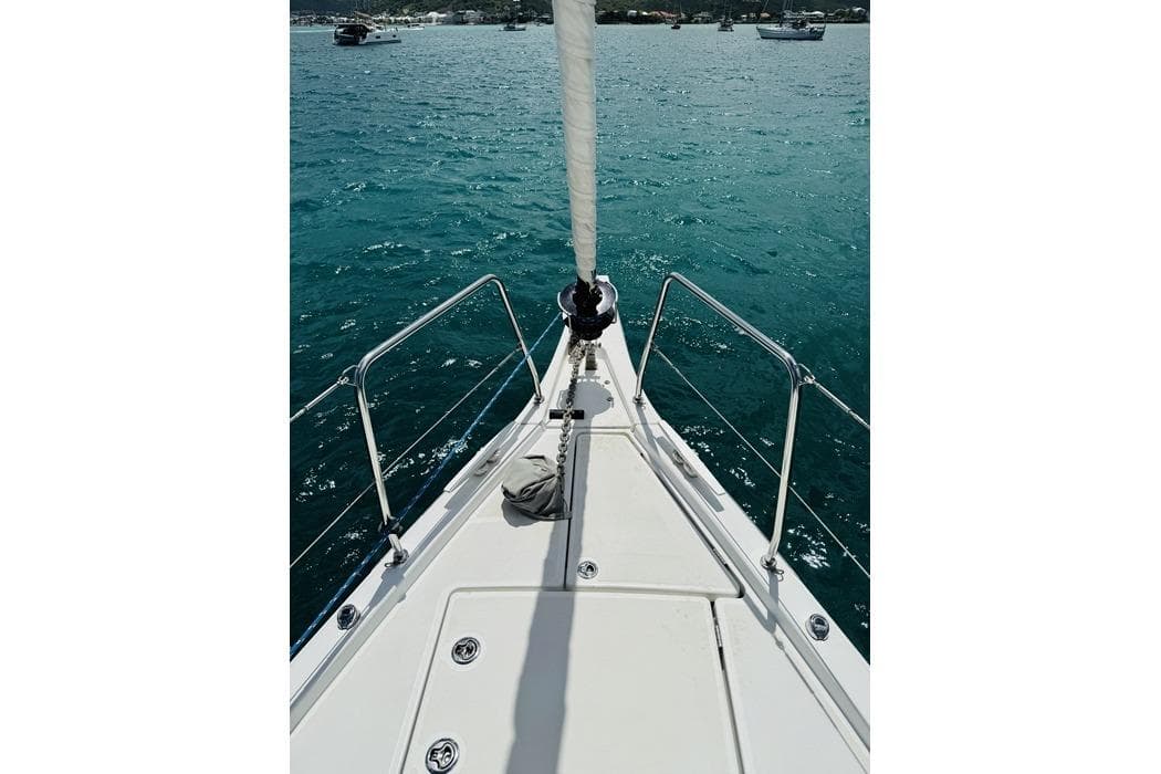 Bow view of 2020 Beneteau Oceanis 46.1 sailboat on clear blue water.
