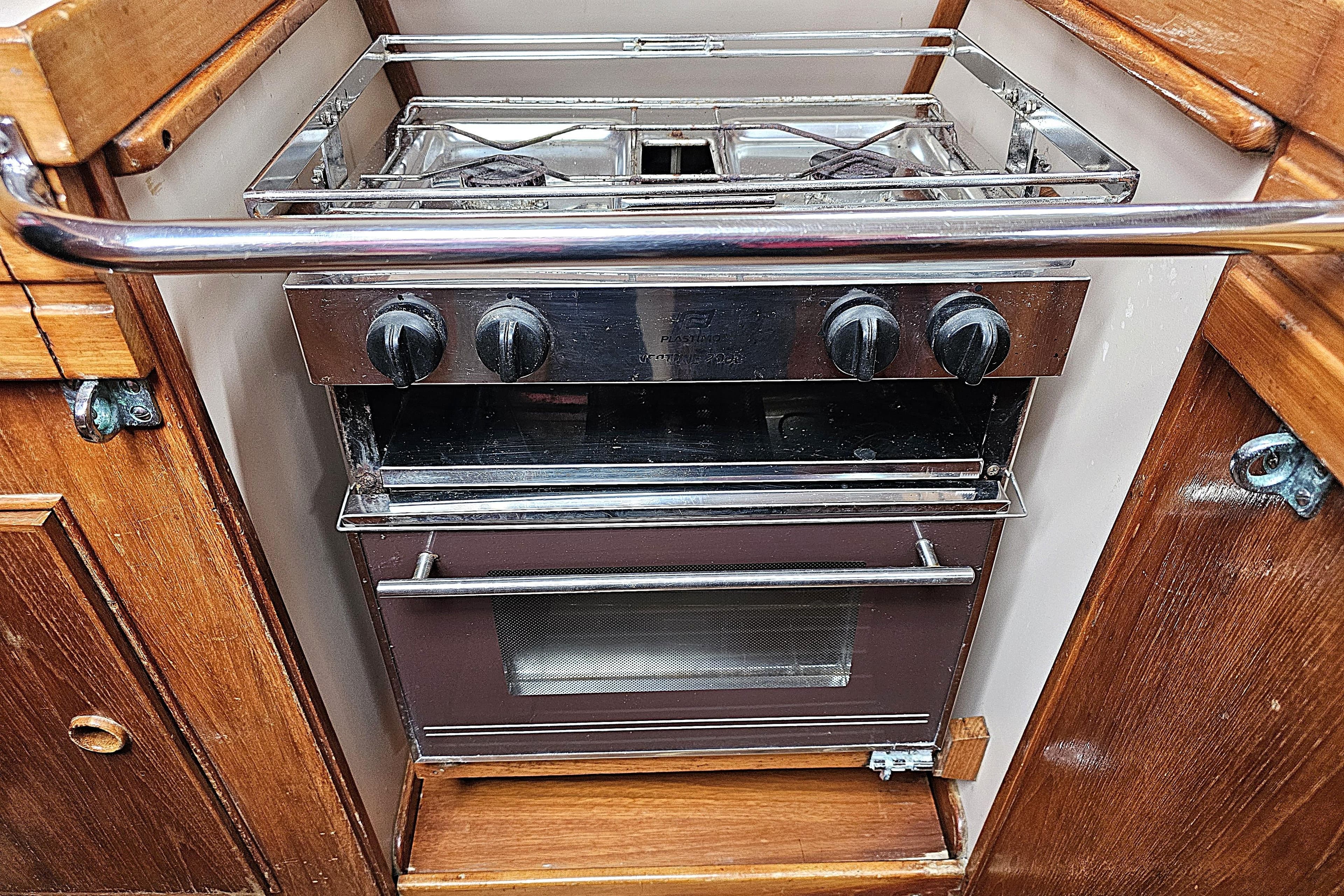 Compact kitchen stove and oven in a 1992 Northshore Yachts Vancouver 34 sailboat.