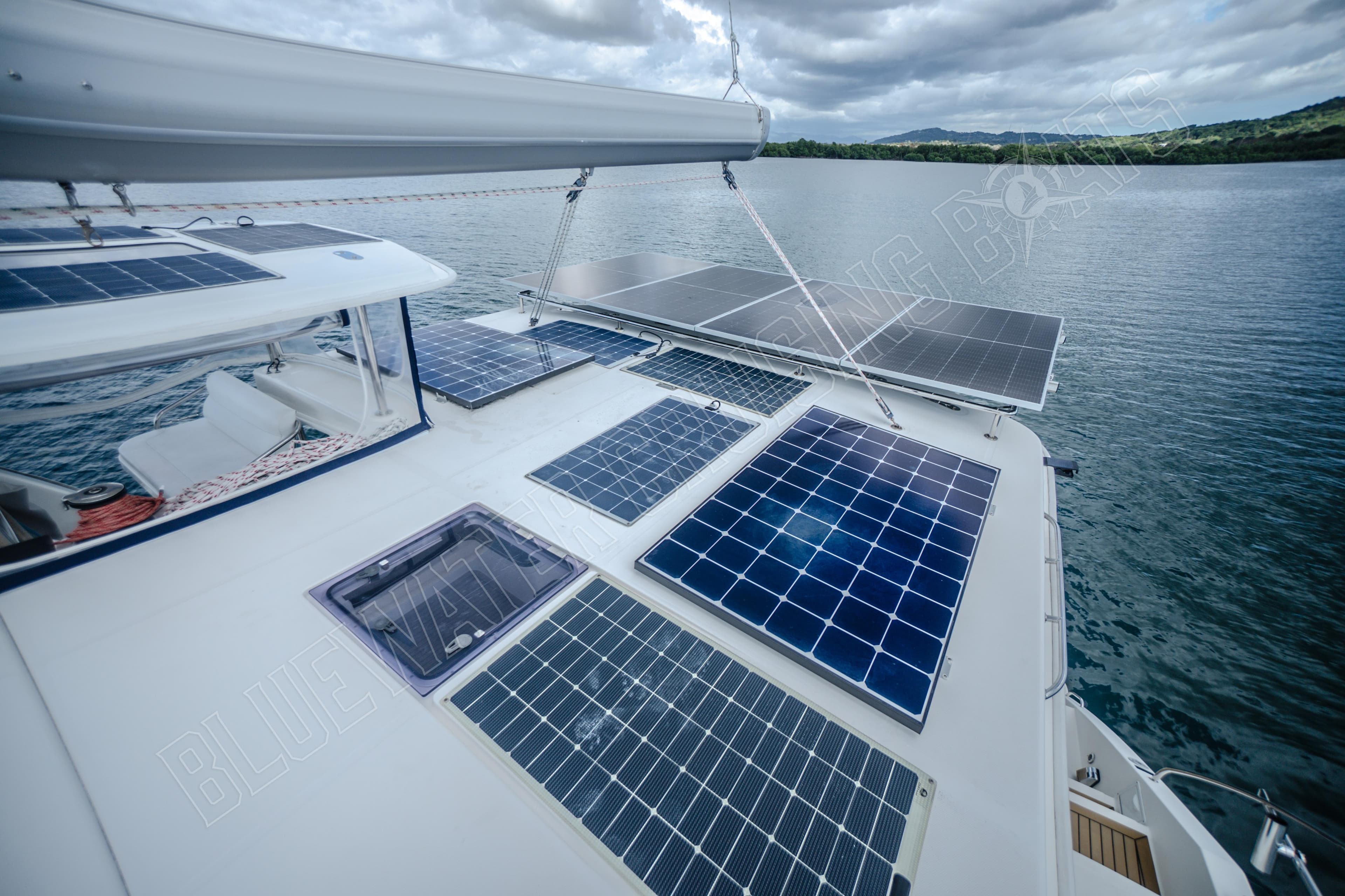 Solar panels on a 2015 Leopard 48 catamaran, sailing on a calm lake.