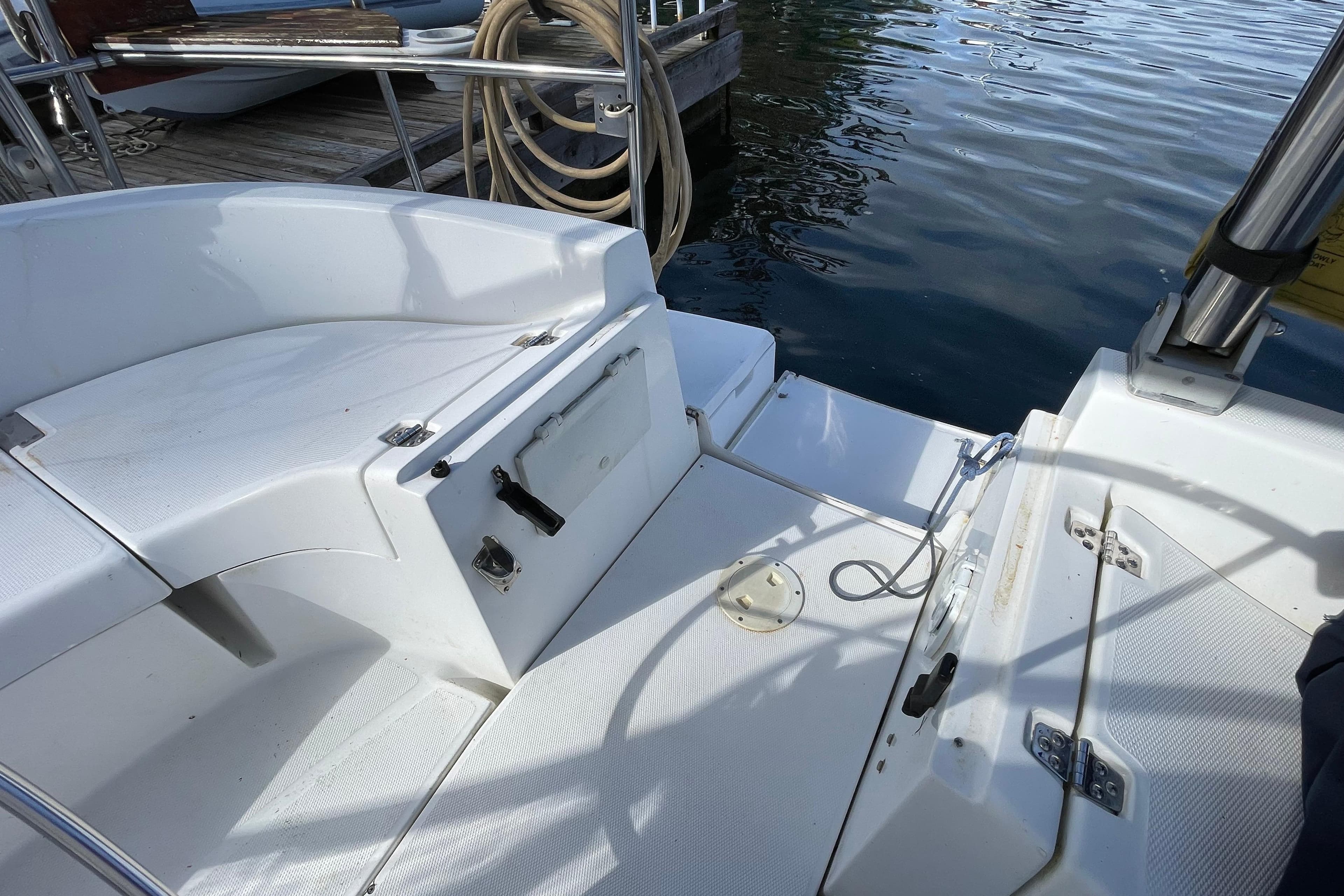 Cockpit of a 2000 Hunter 340 sailboat, featuring white seating and deck details.