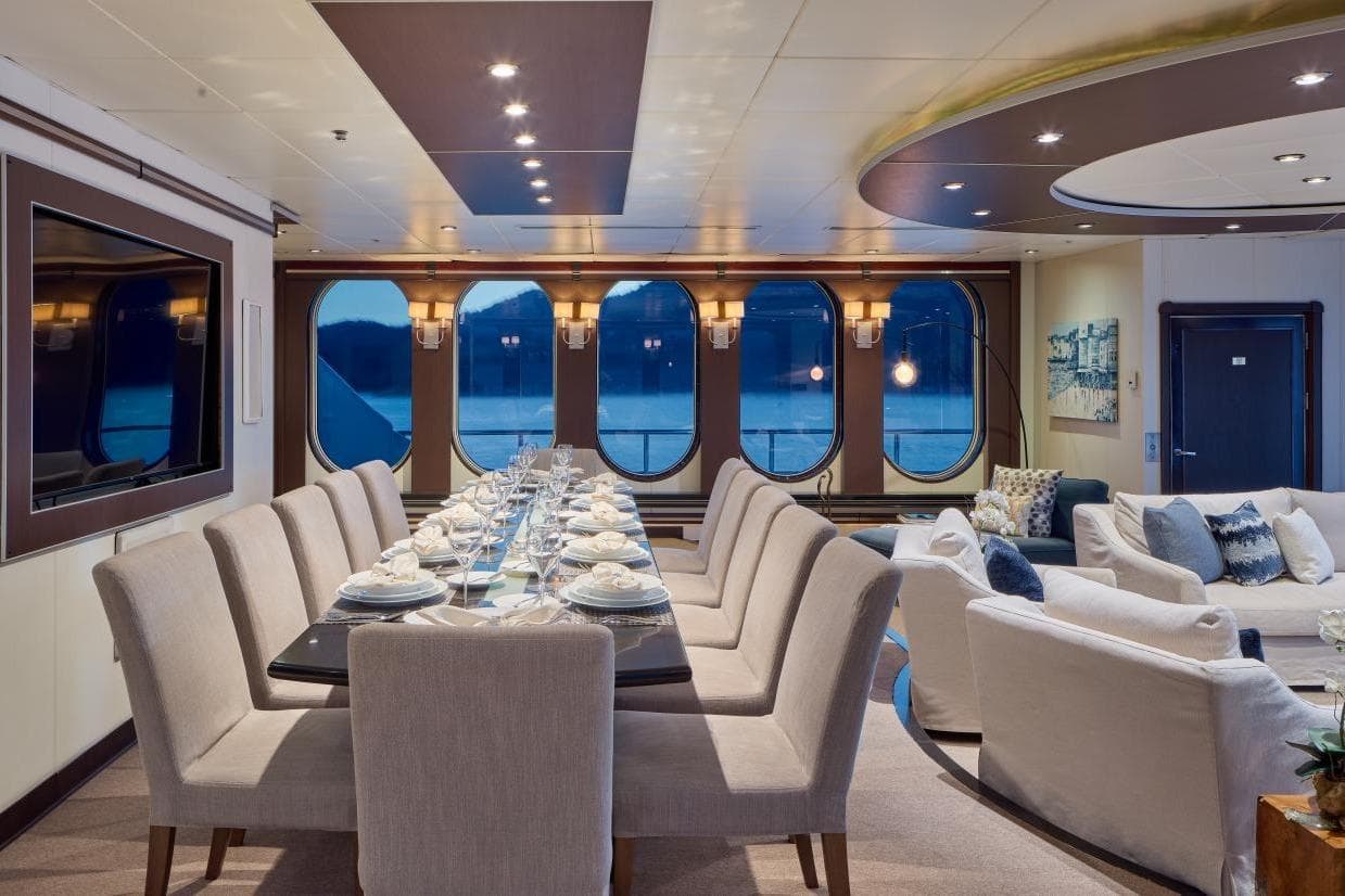 Luxurious dining area on 1982 Shadow Marine Custom Expedition Yacht, featuring elegant seating and ocean views.