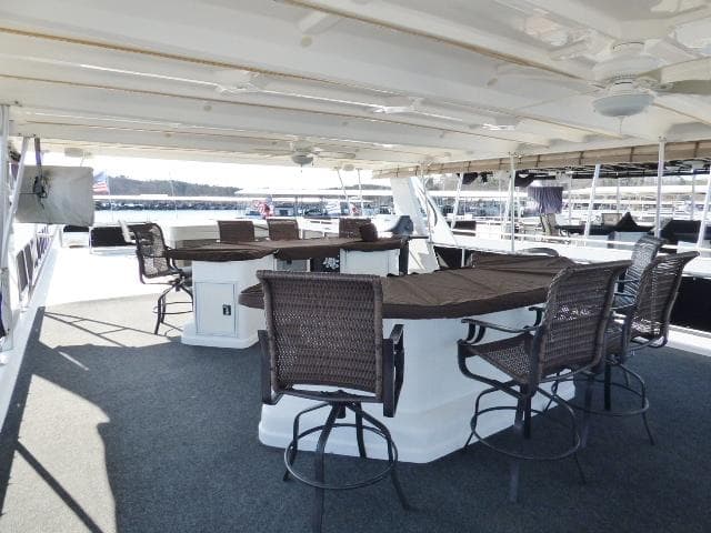 Spacious deck area on 2006 Thoroughbred 20x90 yacht with seating and tables.