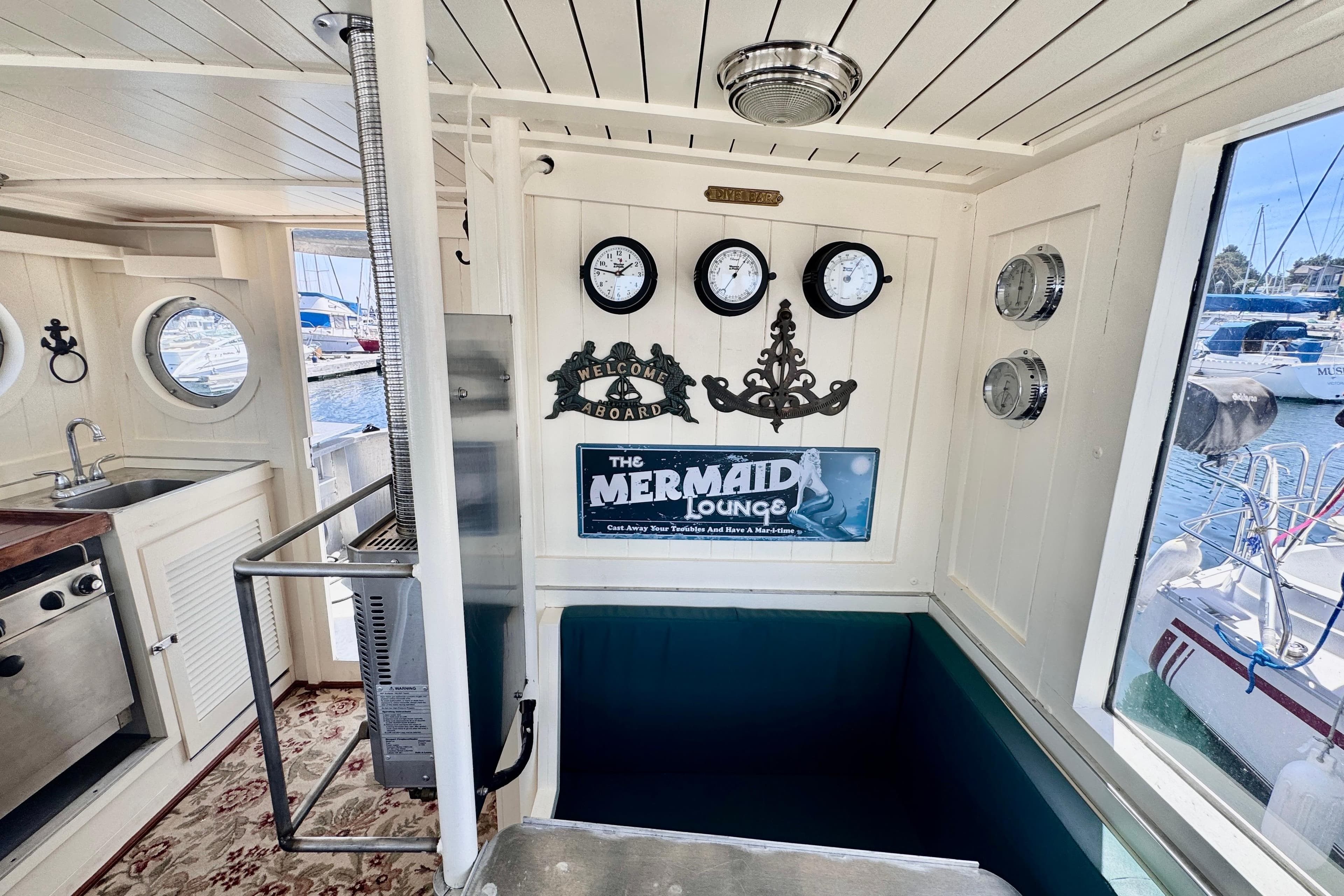 Interior of 2010 Custom Island Trader boat with nautical decor and "Mermaid Lounge" sign.