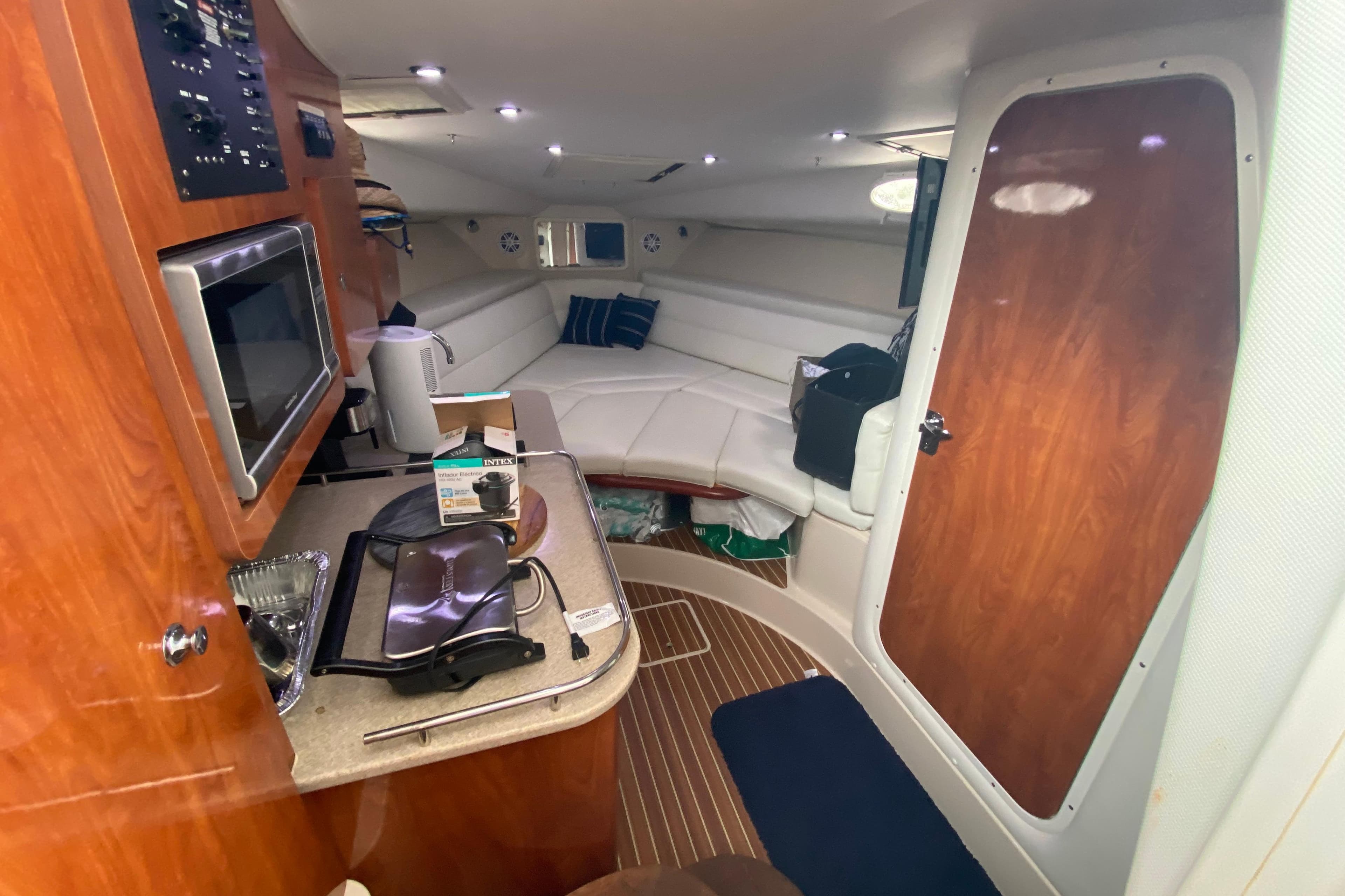 Interior of 2014 Wellcraft 340 Coastal boat with kitchenette and seating area.