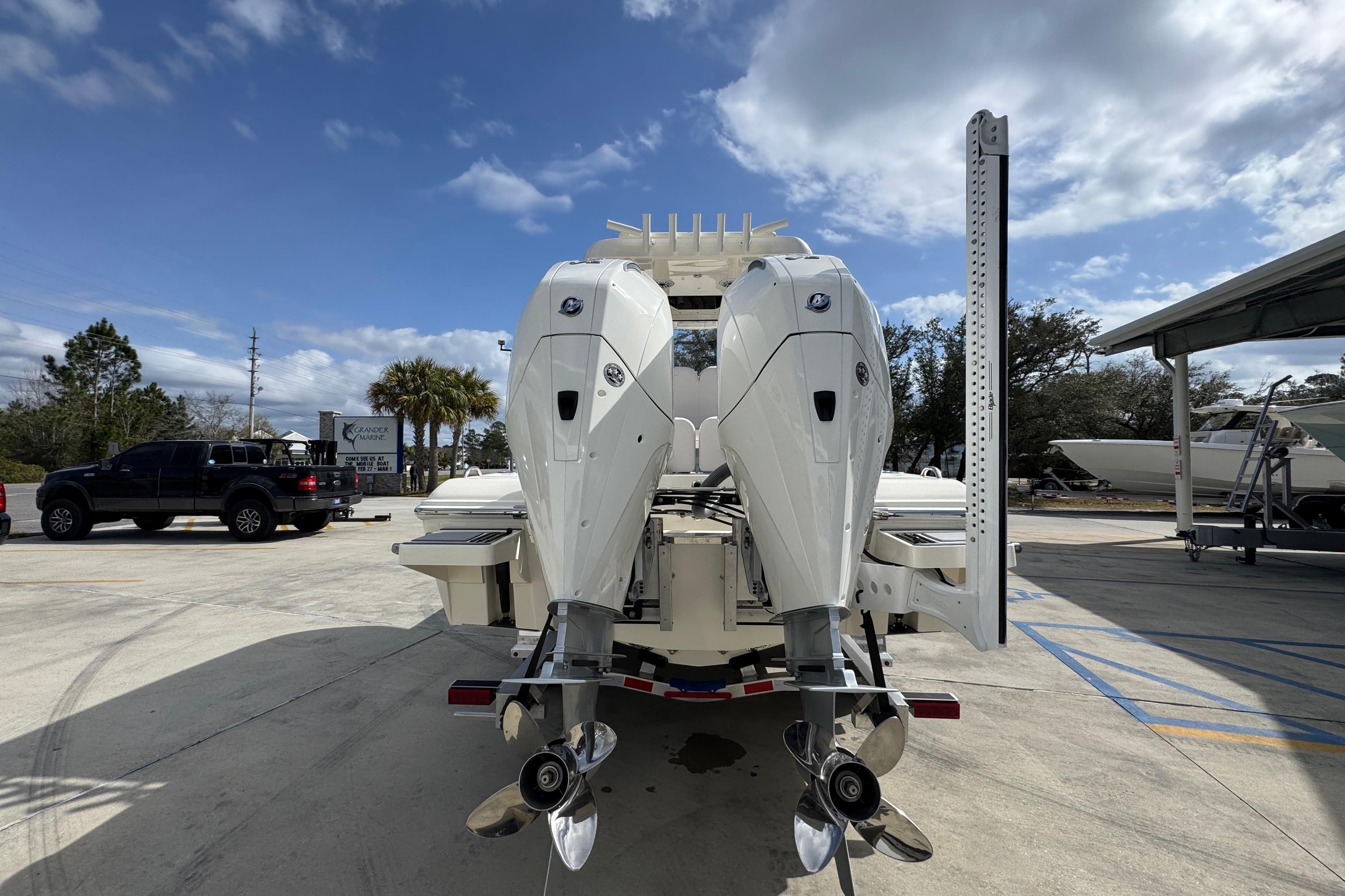 2026 ShearWater 270 SS Open Carolina boat with dual outboard motors in a parking lot.