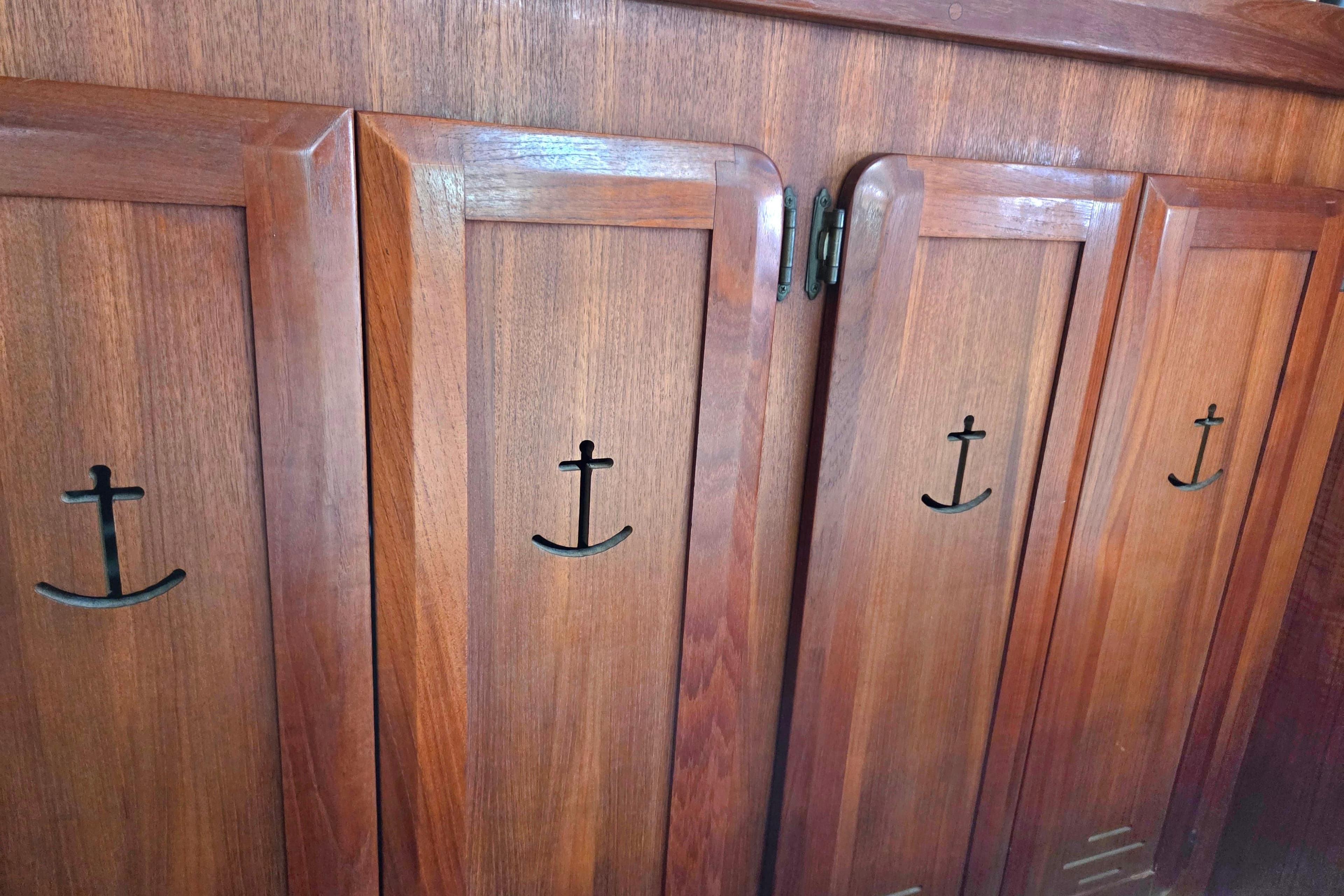Wooden cabinet doors with anchor-shaped handles on a 1991 Hunter Passage 42 yacht.