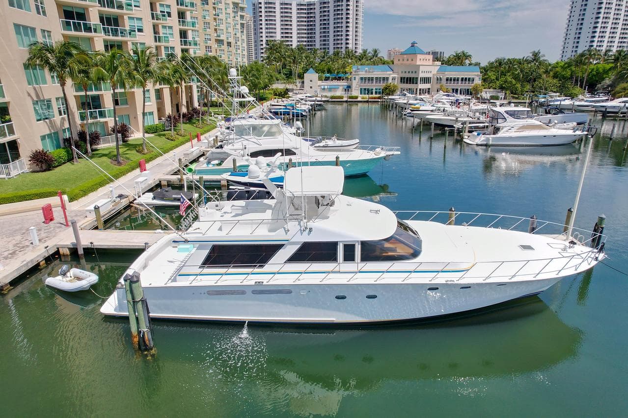 1991 Jones-Goodell Yachtfish docked in a marina with luxury buildings.