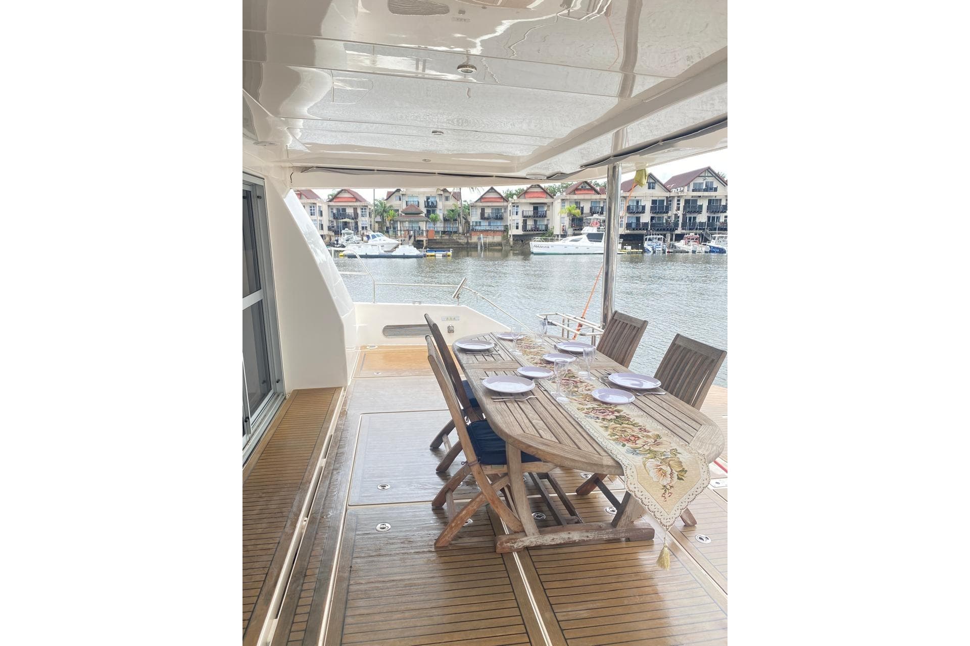 Luxurious 2018 Leopard 58 yacht deck with elegant dining setup overlooking marina.