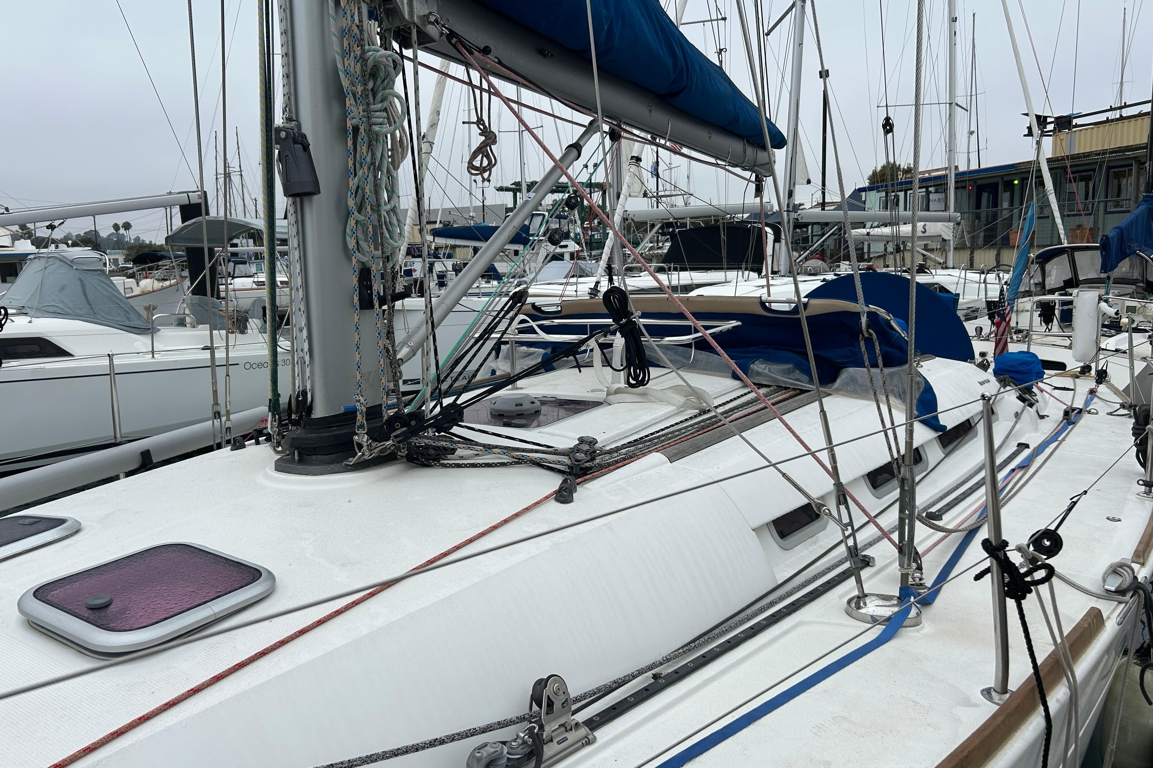 2012 Beneteau First 40 sailboat docked in marina, featuring rigging and deck details.