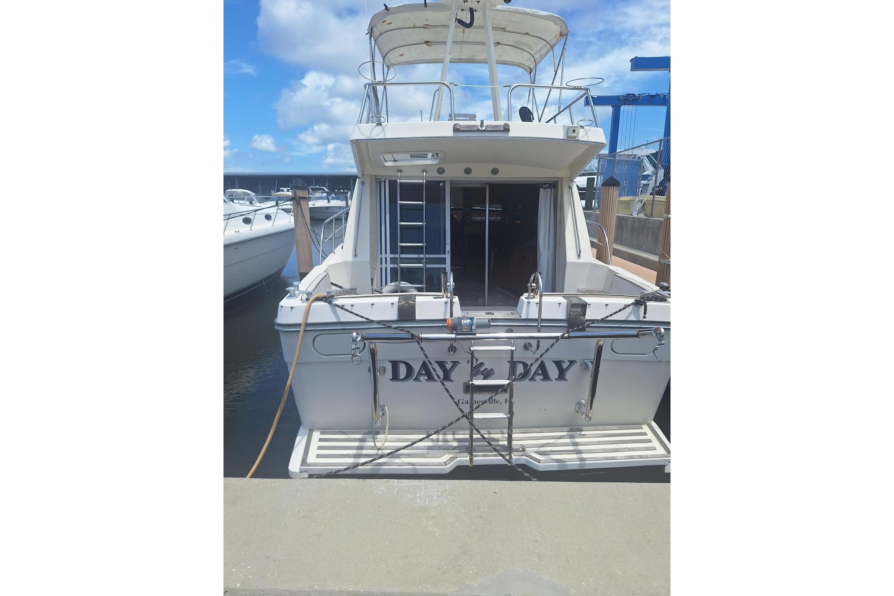 1988 Birchwood 44TS yacht docked at marina under blue sky.
