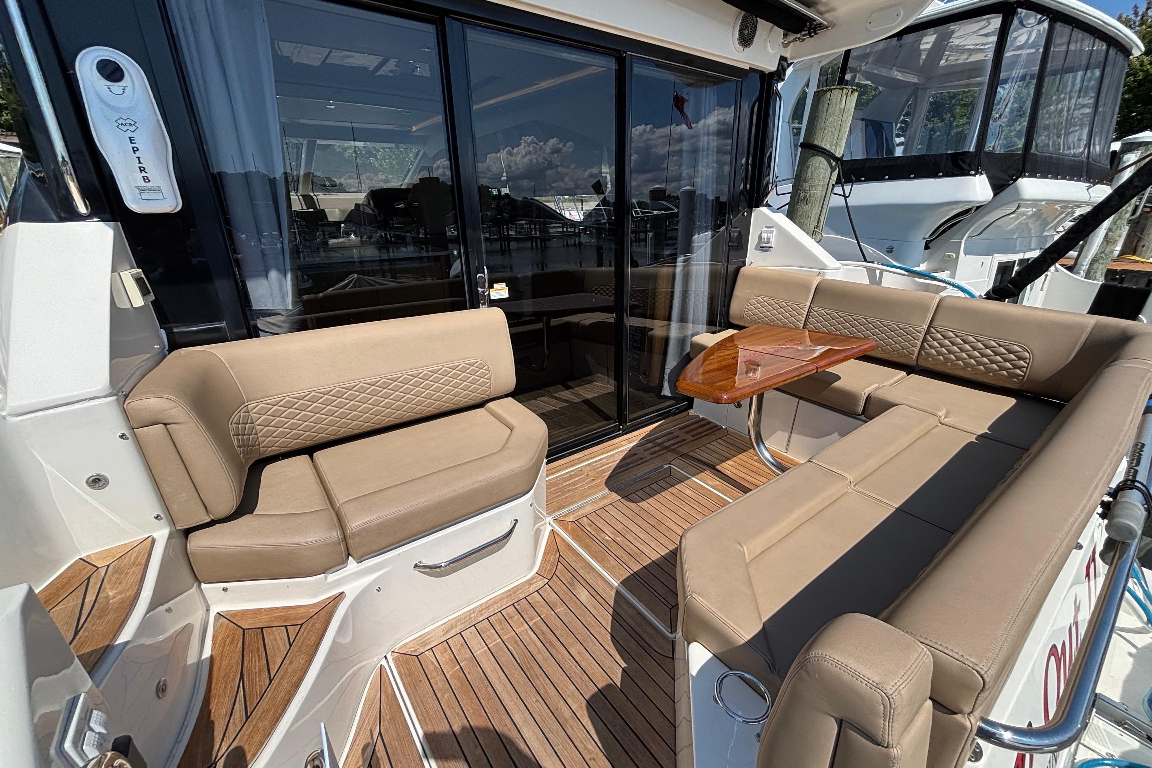Luxurious 2018 Sea Ray Sundancer 460 yacht with elegant outdoor seating and wooden deck.