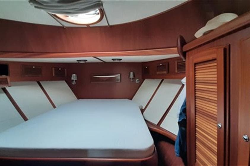 Luxurious cabin interior of 2004 CNP Lobster 44 yacht with wooden finishes.