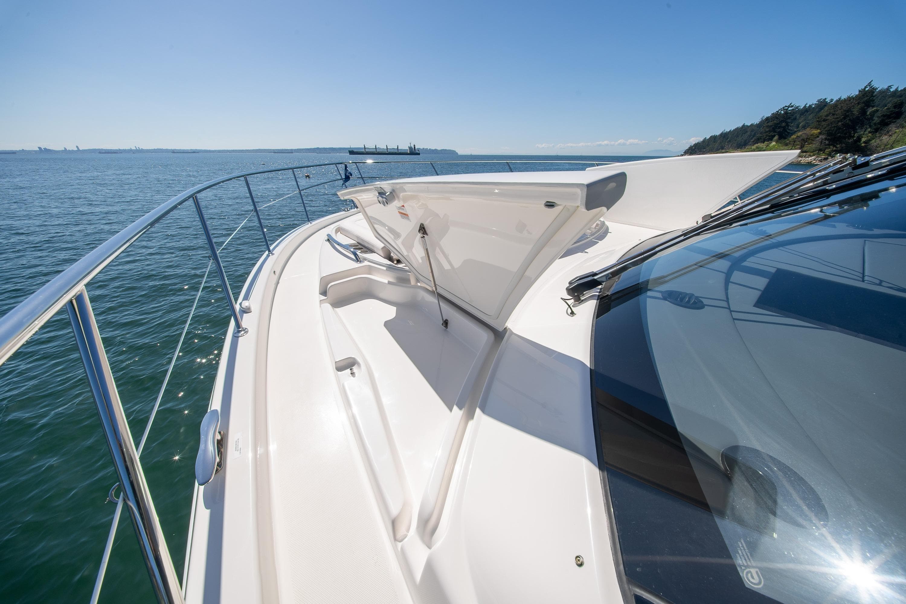 2026 Riviera 4600 Sport Yacht Platinum Edition cruising on a sunny day, showcasing sleek design.